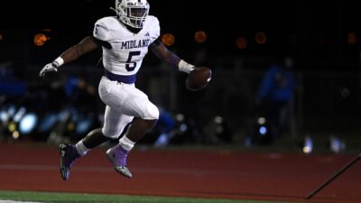Midland High's Elijah McCoy jumps after his touchdown against Frenship in a District 2-6A high school football game