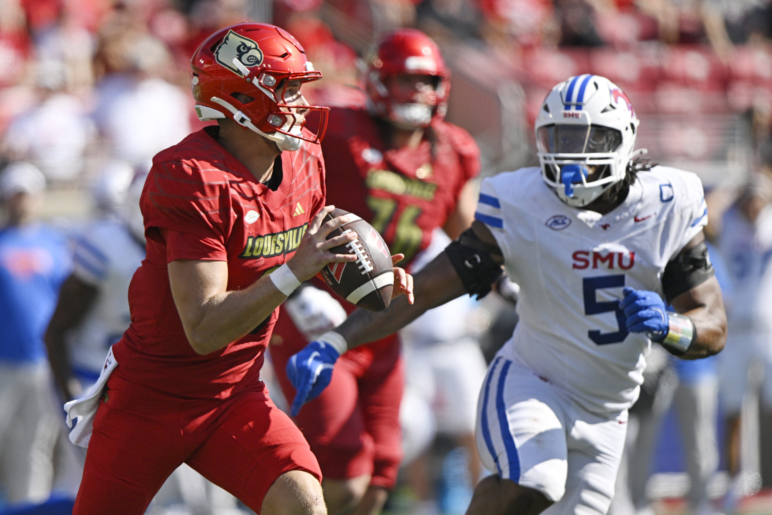 Oct 5, 2024; Louisville, Kentucky, USA; Louisville Cardinals quarterback Tyler Shough (9) looks to pass against Southern Methodist Mustangs defensive end Elijah Roberts (5) during the second half at L&N Federal Credit Union Stadium.