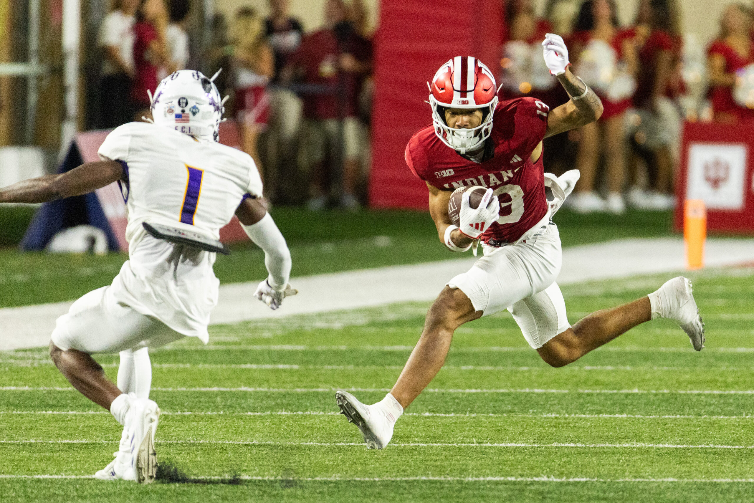 Sep 6, 2024; Bloomington, Indiana, USA; Indiana Hoosiers wide receiver Elijah Sarratt (13) runs the ball while Western Illinois Leathernecks defensive back Jeremiah Piper (1) defends in the second half at Memorial Stadium.
