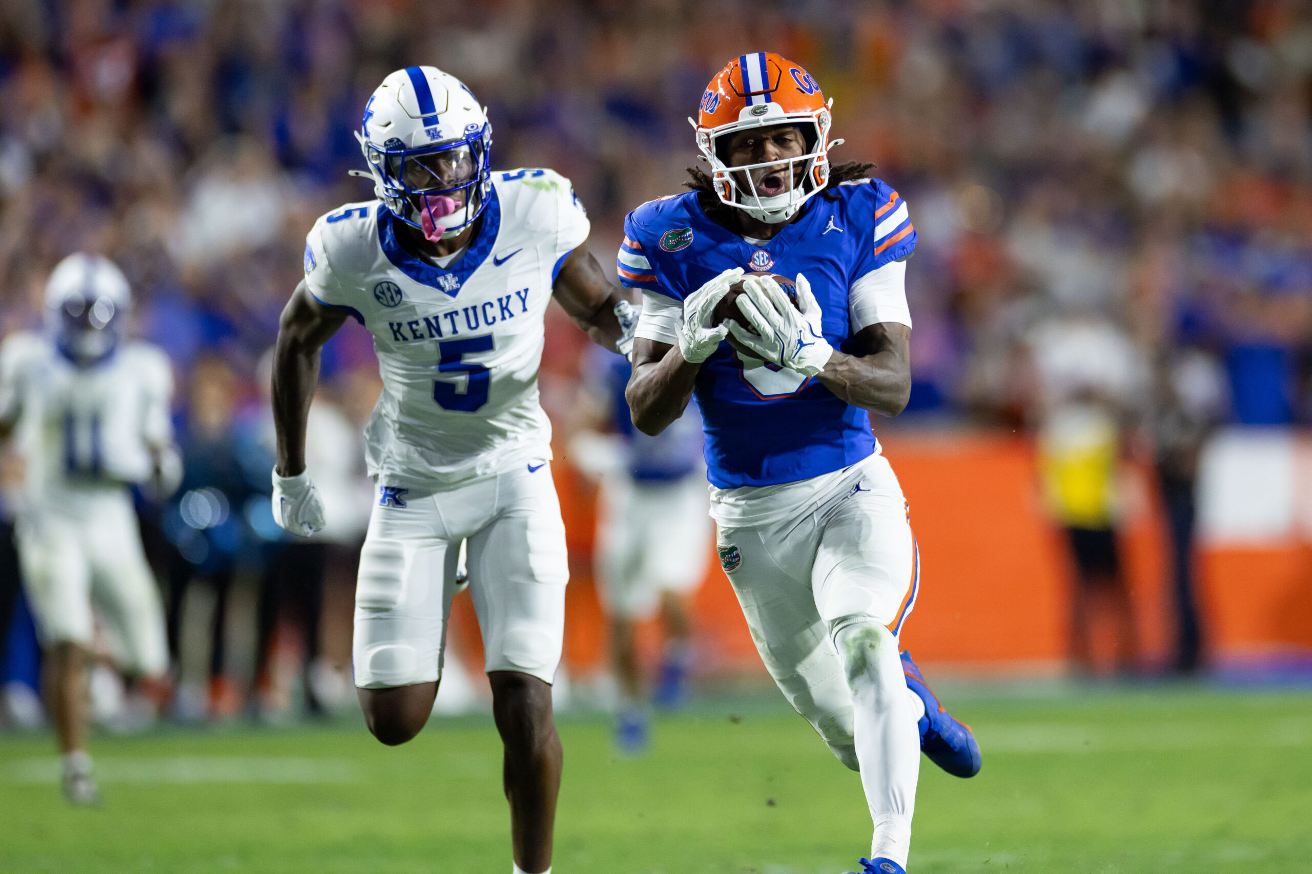 Nov 16, 2024; Gainesville, Florida, USA; Florida Gators wide receiver Elijhah Badger (6) catches the ball for a touchdown over LSU Tigers cornerback Ashton Stamps (1) during the first half at Ben Hill Griffin Stadium. 