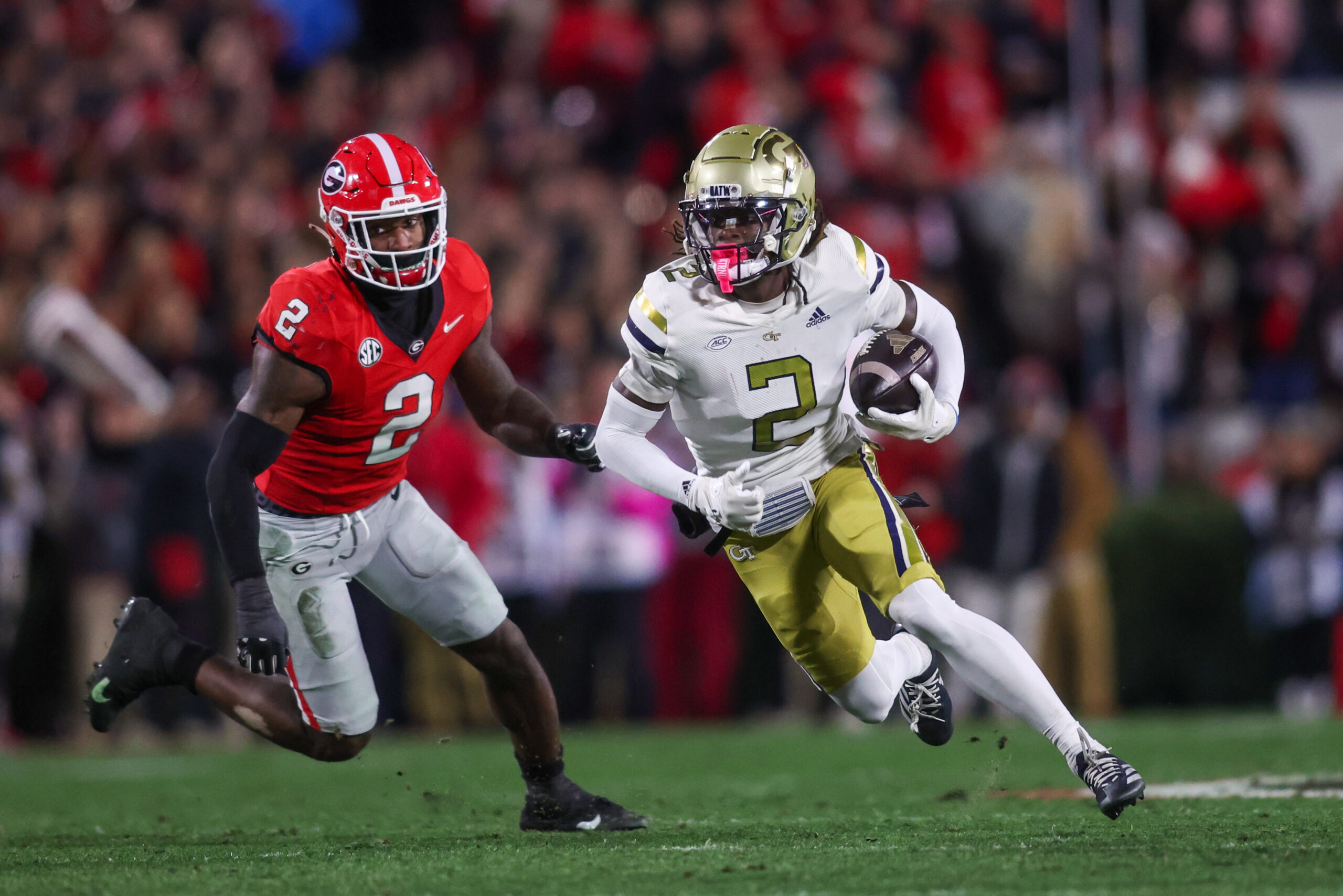 Nov 29, 2024; Athens, Georgia, USA; Georgia Tech Yellow Jackets wide receiver Eric Singleton Jr. (2) runs past Georgia Bulldogs linebacker Smael Mondon Jr. (2) in the first quarter at Sanford Stadium. 