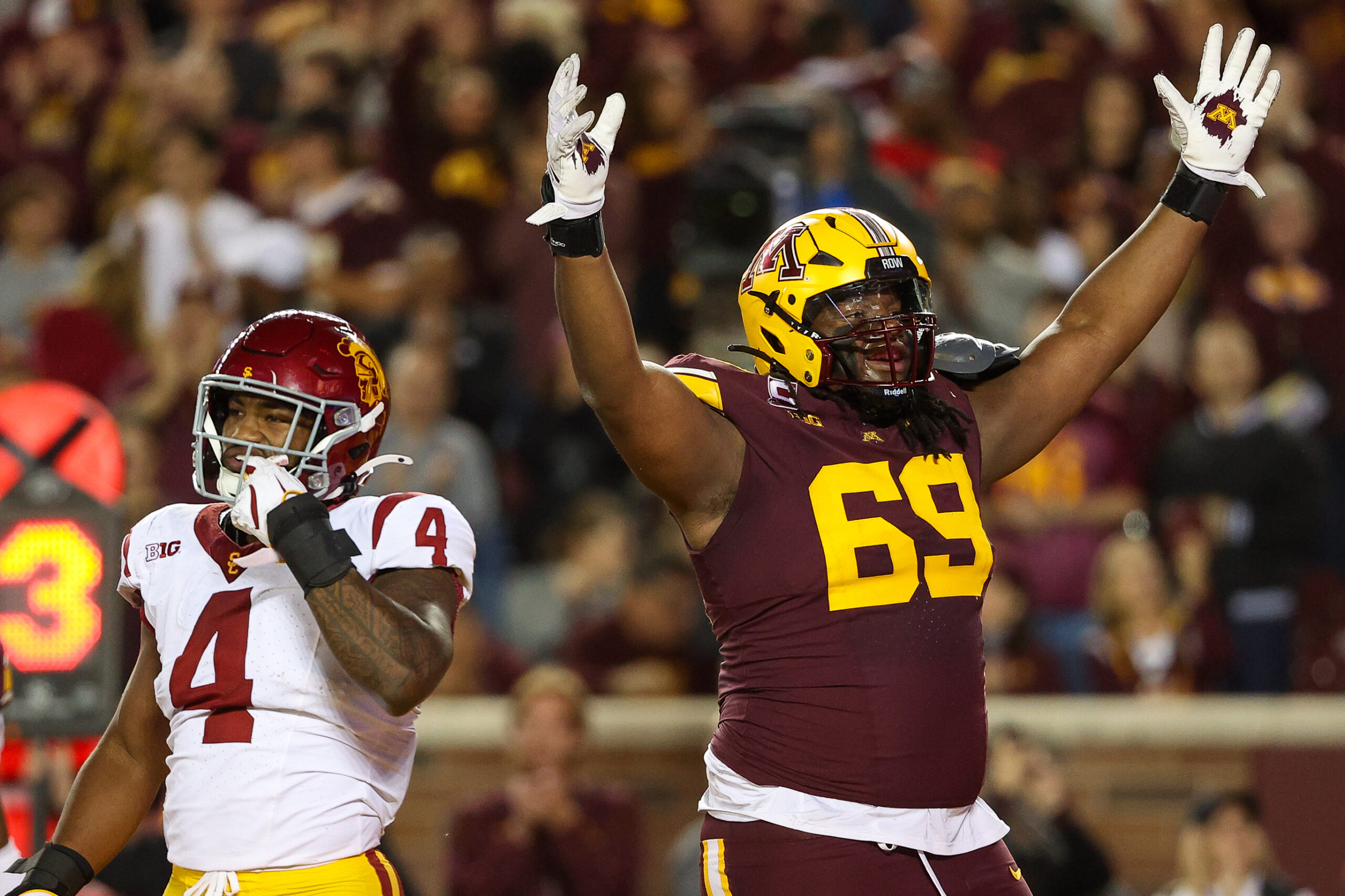 Oct 5, 2024; Minneapolis, Minnesota, USA; Minnesota Golden Gophers offensive lineman Aireontae Ersery (69) celebrates quarterback Max Brosmer's (16) touchdown against the USC Trojans during the first half at Huntington Bank Stadium.