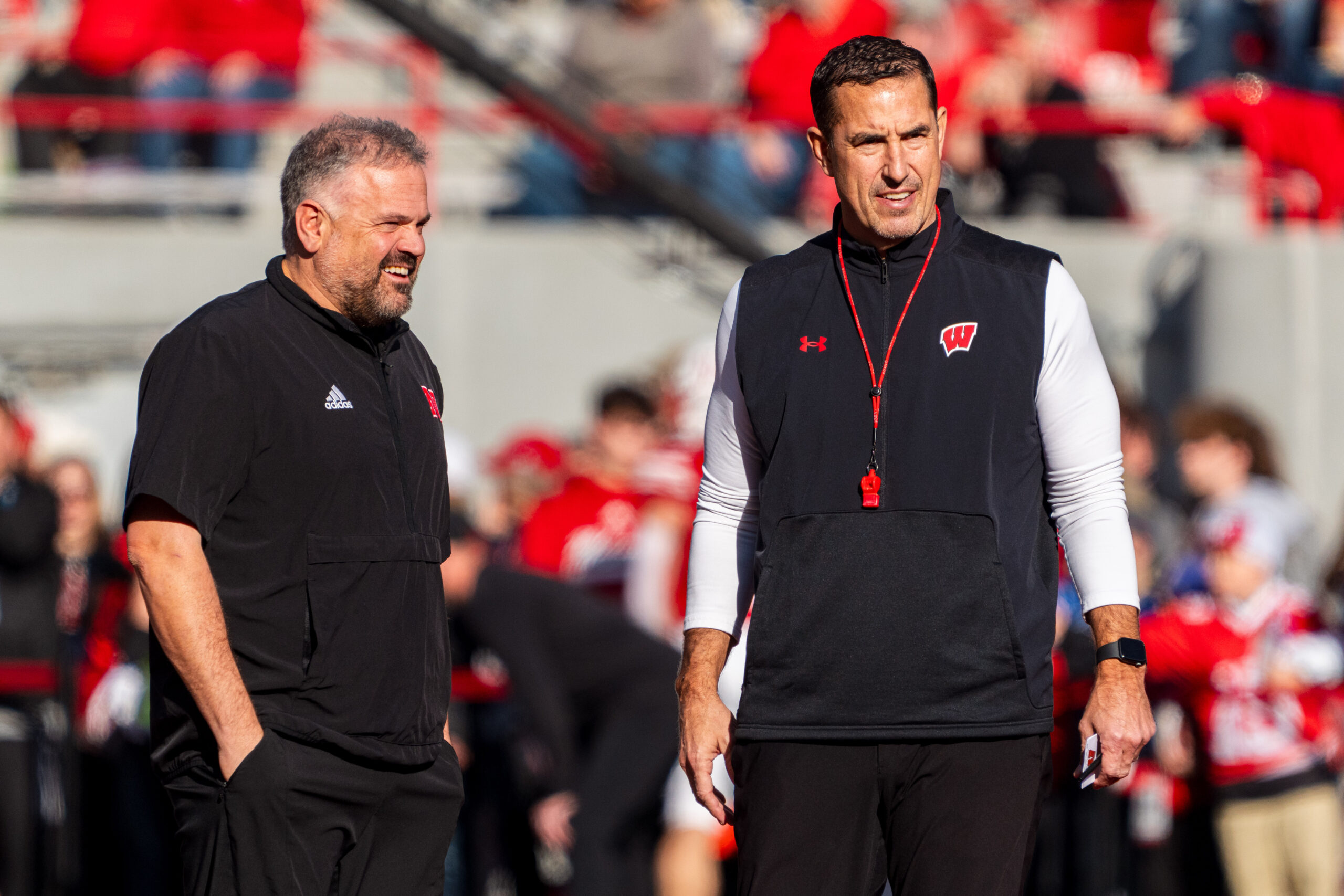 Nov 23, 2024; Lincoln, Nebraska, USA; Nebraska Cornhuskers head coach Matt Rhule and Wisconsin Badgers head coach Luke Fickell talk before a game at Memorial Stadium.
