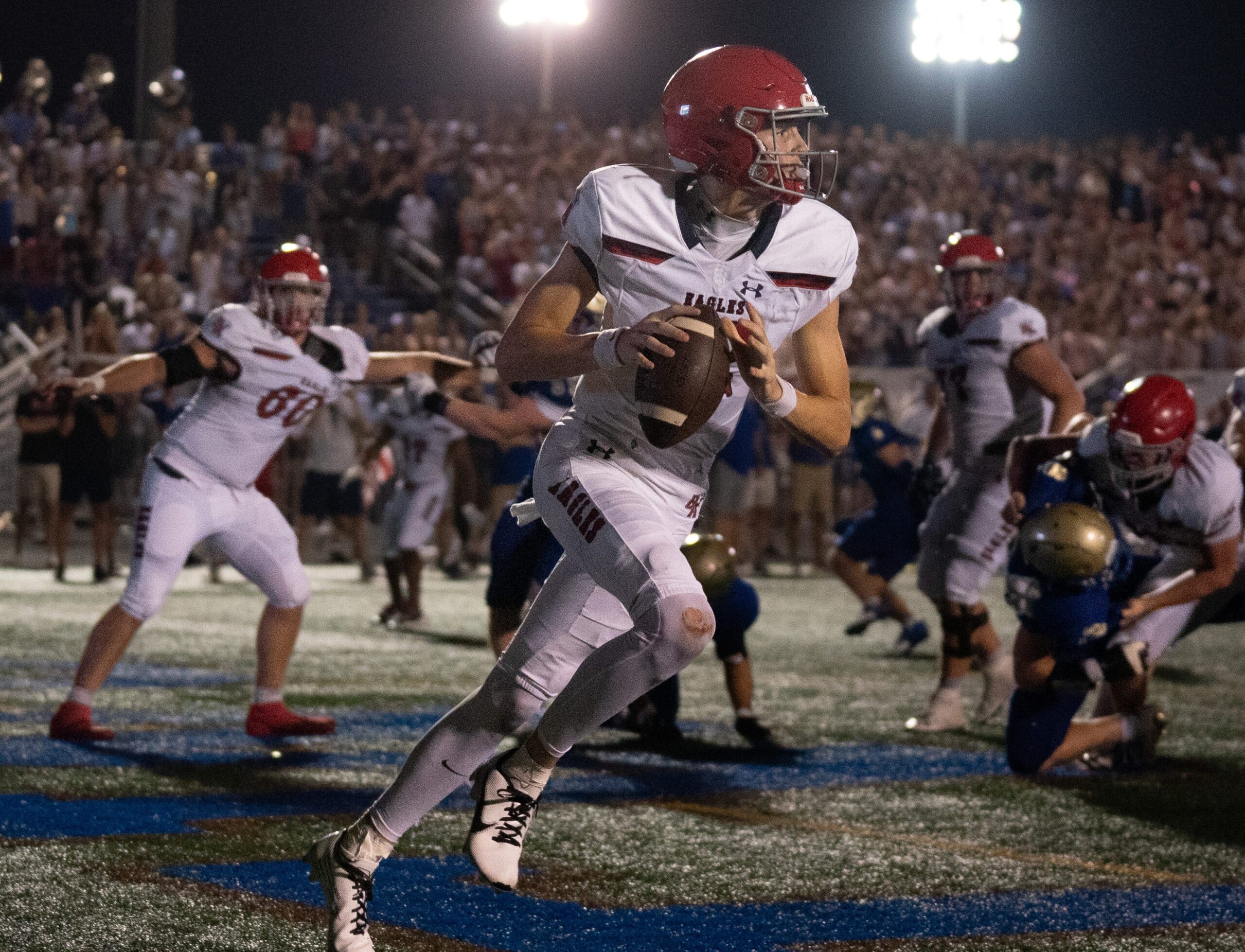 Brentwood Academy's George MacIntyre (12) has to scramble in his own end zone as Brentwood pressures him late in the fourth quarter at James C. Parker Stadium Friday night, Aug. 25, 2023