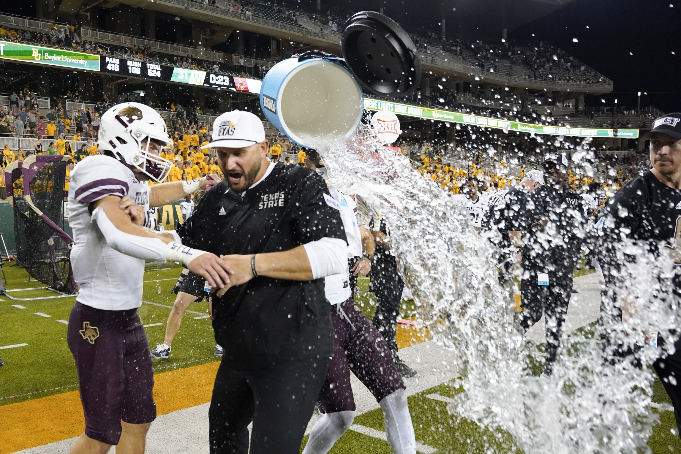 Sep 2, 2023; Waco, Texas, USA; Texas State Bobcats head coach G.J. Kinne avoid the powerade bath following the game against the Baylor Bears during the second half at McLane Stadium.