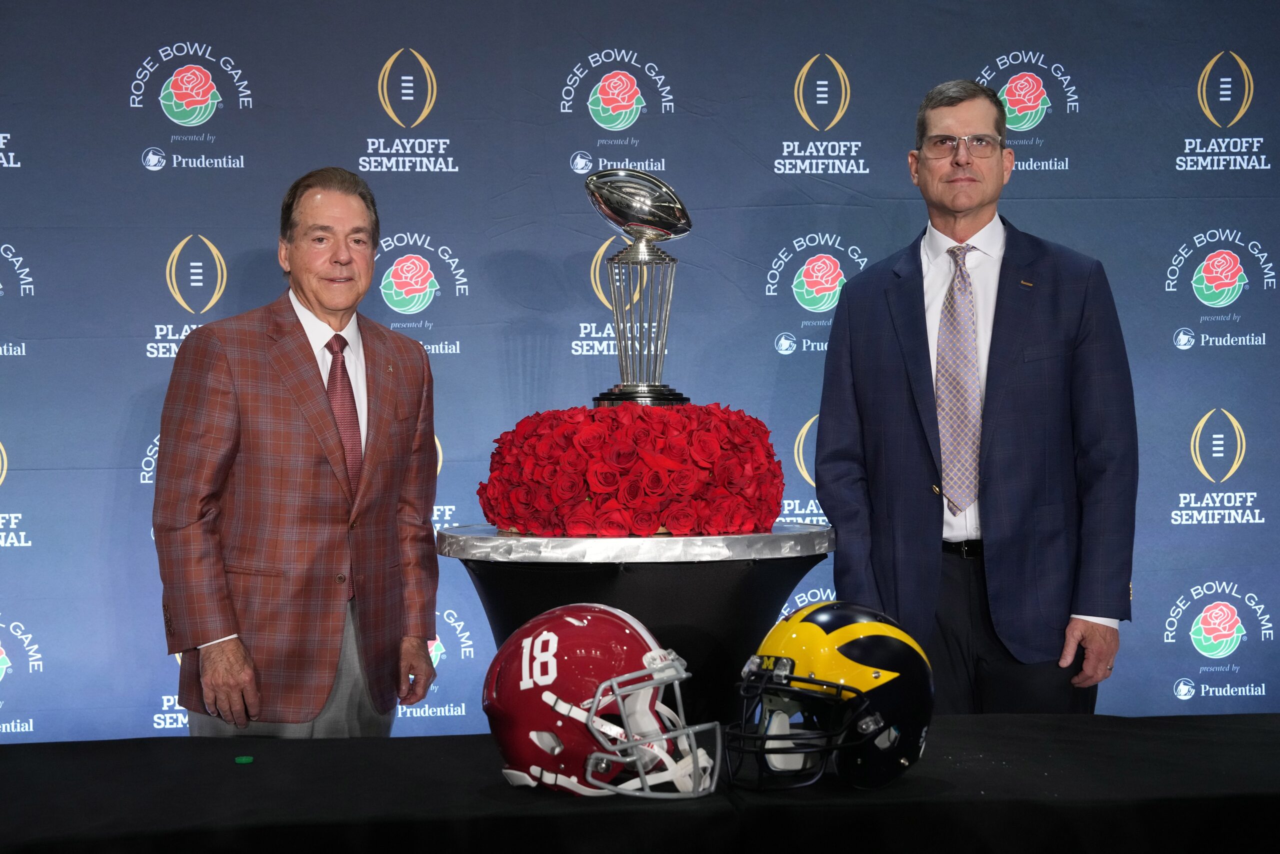 Dec 31, 2023; Los Angeles, CA, USA; Alabama Crimson Tide head coach Nick Saban (left) and Michigan Wolverines head coach Jim Harbaugh pose with the Leishman Trophy at the Rose Bowl coaches press conference at the Sheraton Grand