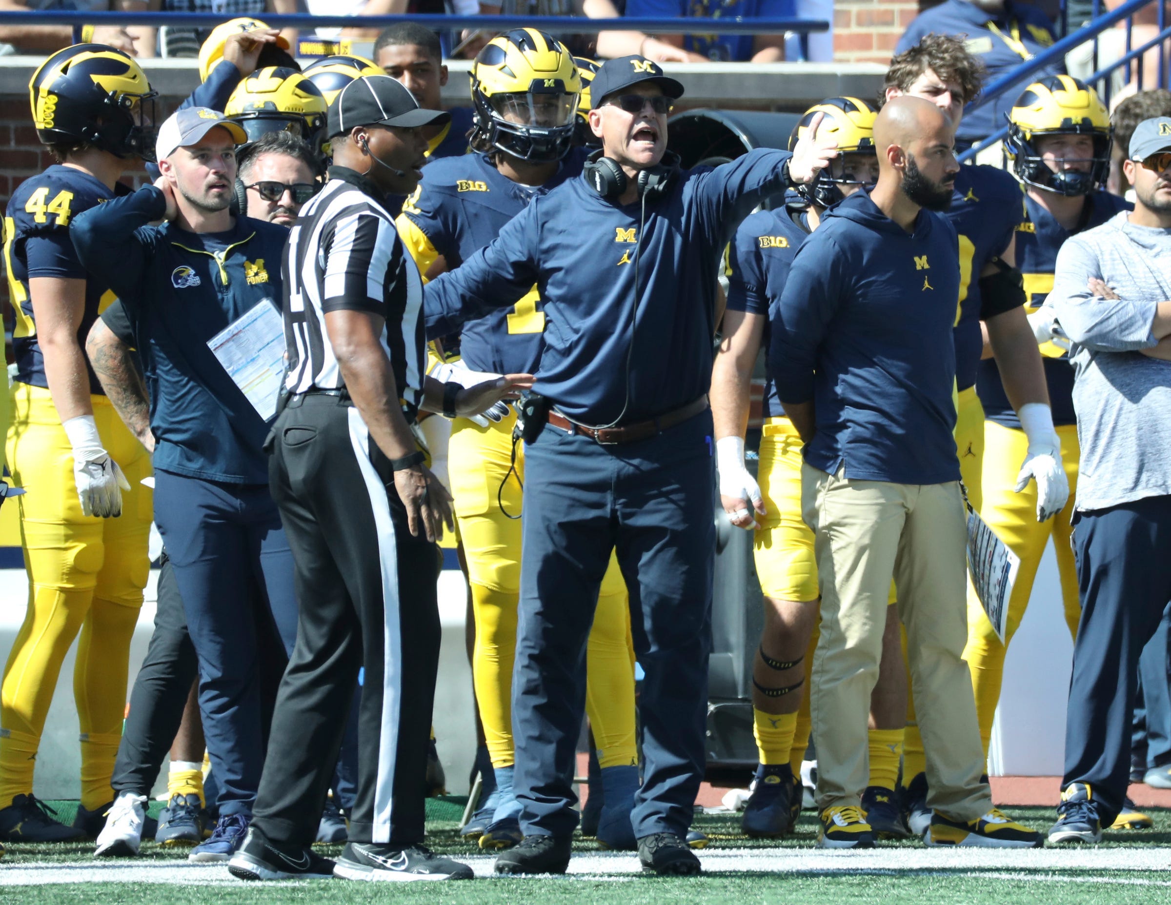Connor Stalions, left, stands next to Michigan coach Jim Harbaugh during the team's game against Rutgers, Sept. 23, 2023, at Michigan Stadium in Ann Arbor.