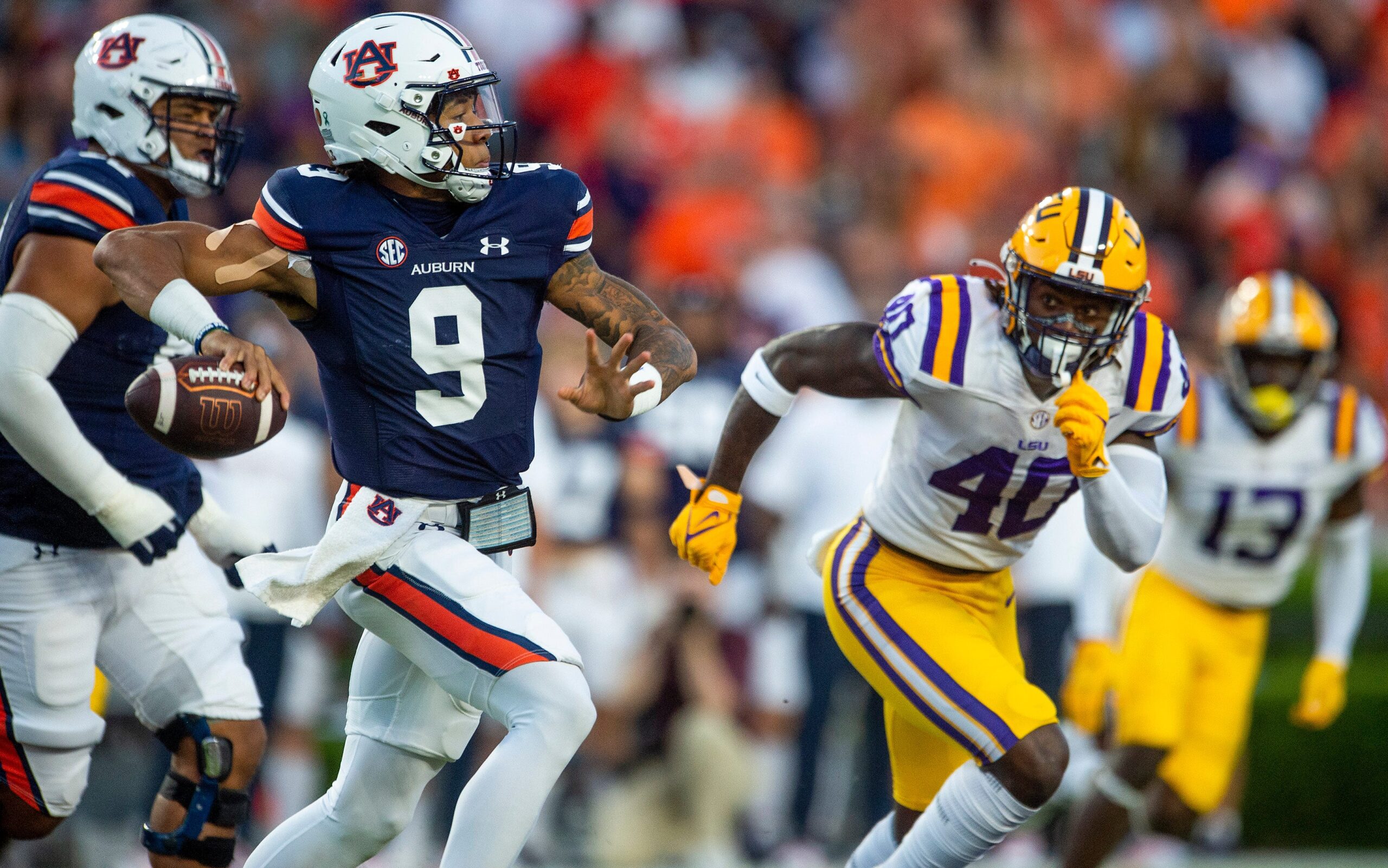 Auburn Tigers quarterback Robby Ashford (9) passes as LSU Tigers linebacker Harold Perkins Jr. (40) closes as the Auburn Tigers take on the LSU Tigers at Jordan-Hare Stadium in Auburn, Ala., on Saturday, Oct. 1, 2022.