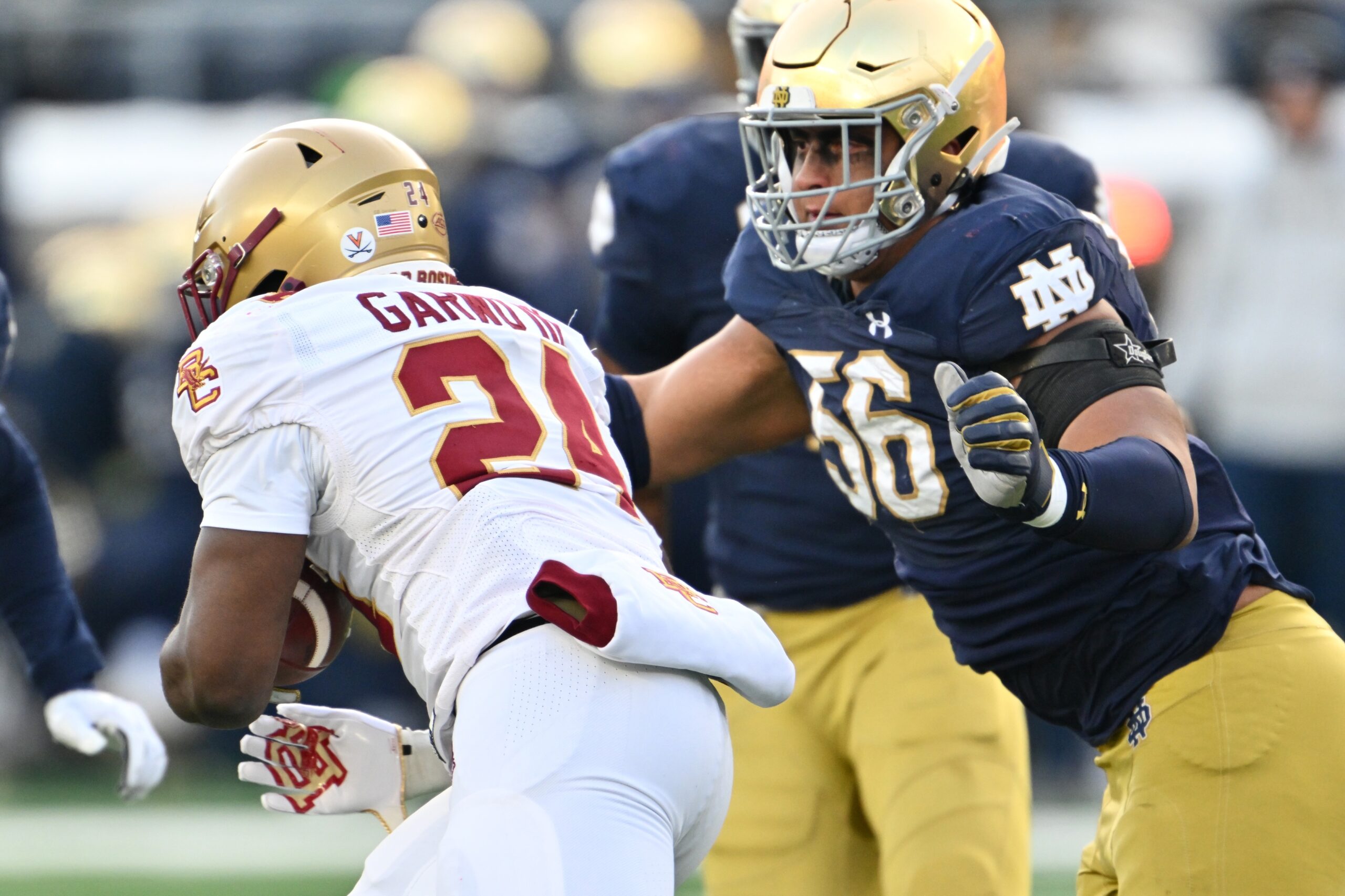 Nov 19, 2022; South Bend, Indiana, USA; Boston College Eagles running back Pat Garwo (24) runs the ball as Notre Dame Fighting Irish defensive lineman Howard Cross III (56) prepares to tackle in the second quarter at Notre Dame Stadium.