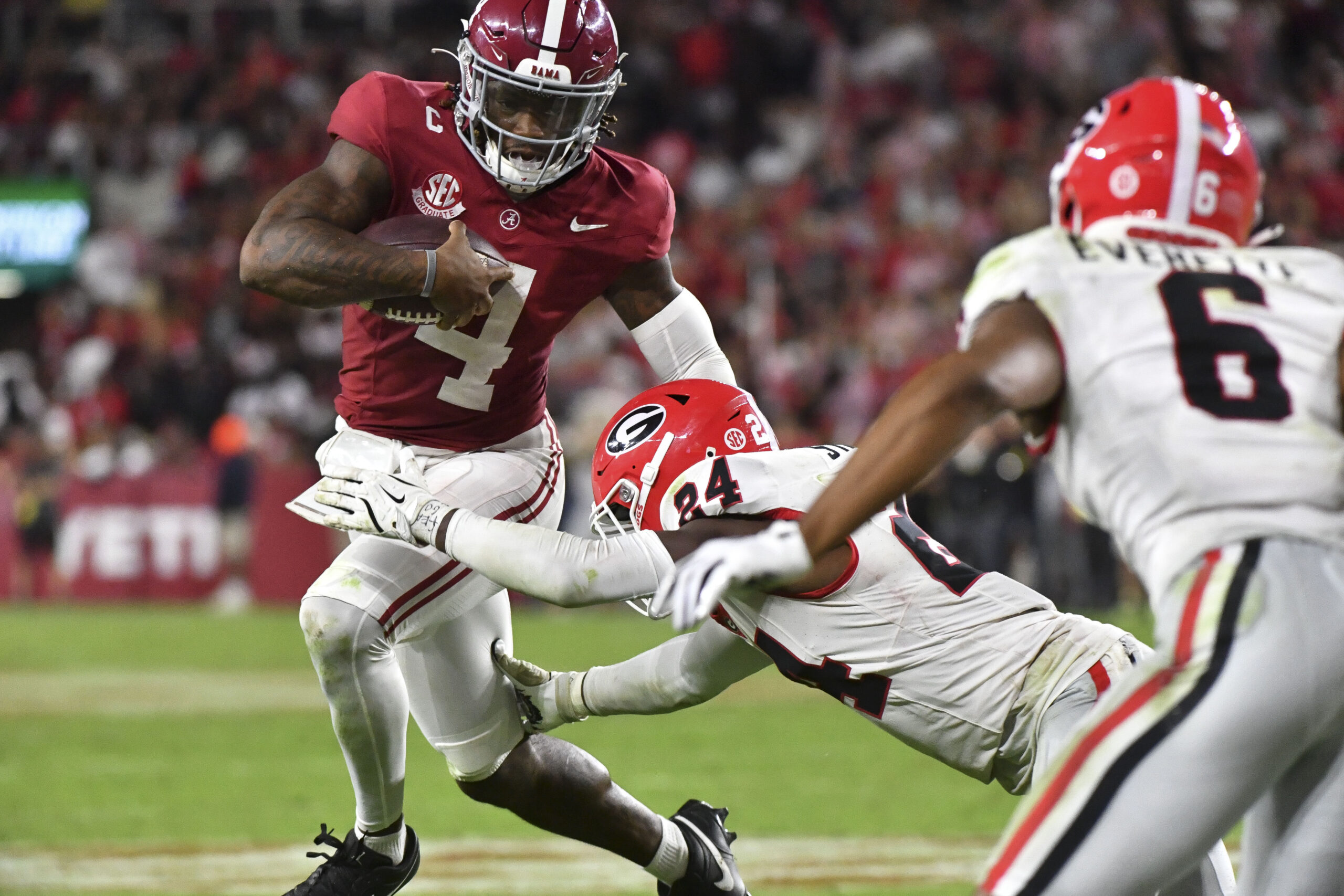 Sep 28, 2024; Tuscaloosa, Alabama, USA; Georgia Bulldogs defensive back Malaki Starks (24) tackles Alabama Crimson Tide quarterback Jalen Milroe (4) at Bryant-Denny Stadium. Alabama defeated Georgia 41-34.