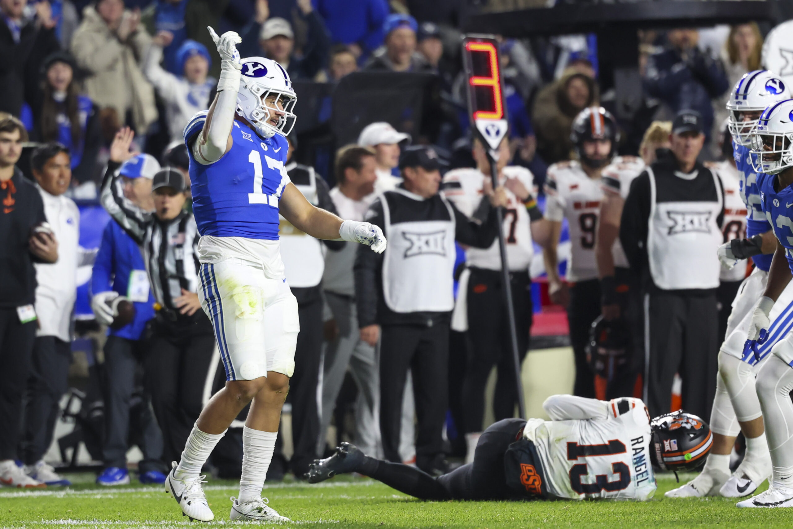 Oct 18, 2024; Provo, Utah, USA; Brigham Young Cougars linebacker Jack Kelly (17) reacts to a sack of Oklahoma State Cowboys quarterback Garret Rangel (13) during the first quarter at LaVell Edwards Stadium. 