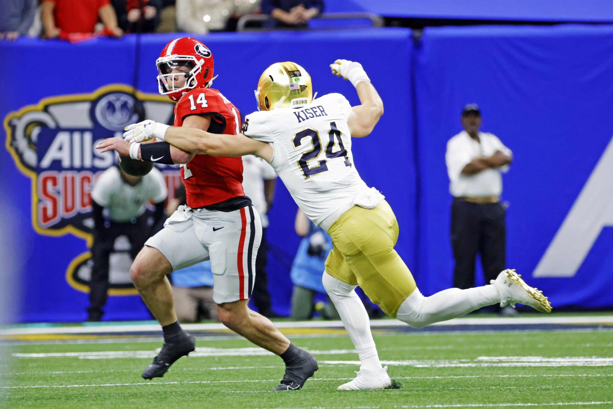 Jan 2, 2025; New Orleans, LA, USA; Georgia Bulldogs quarterback Gunner Stockton (14) controls the ball during the first quarter against Notre Dame Fighting Irish linebacker Jack Kiser (24) at Caesars Superdome.