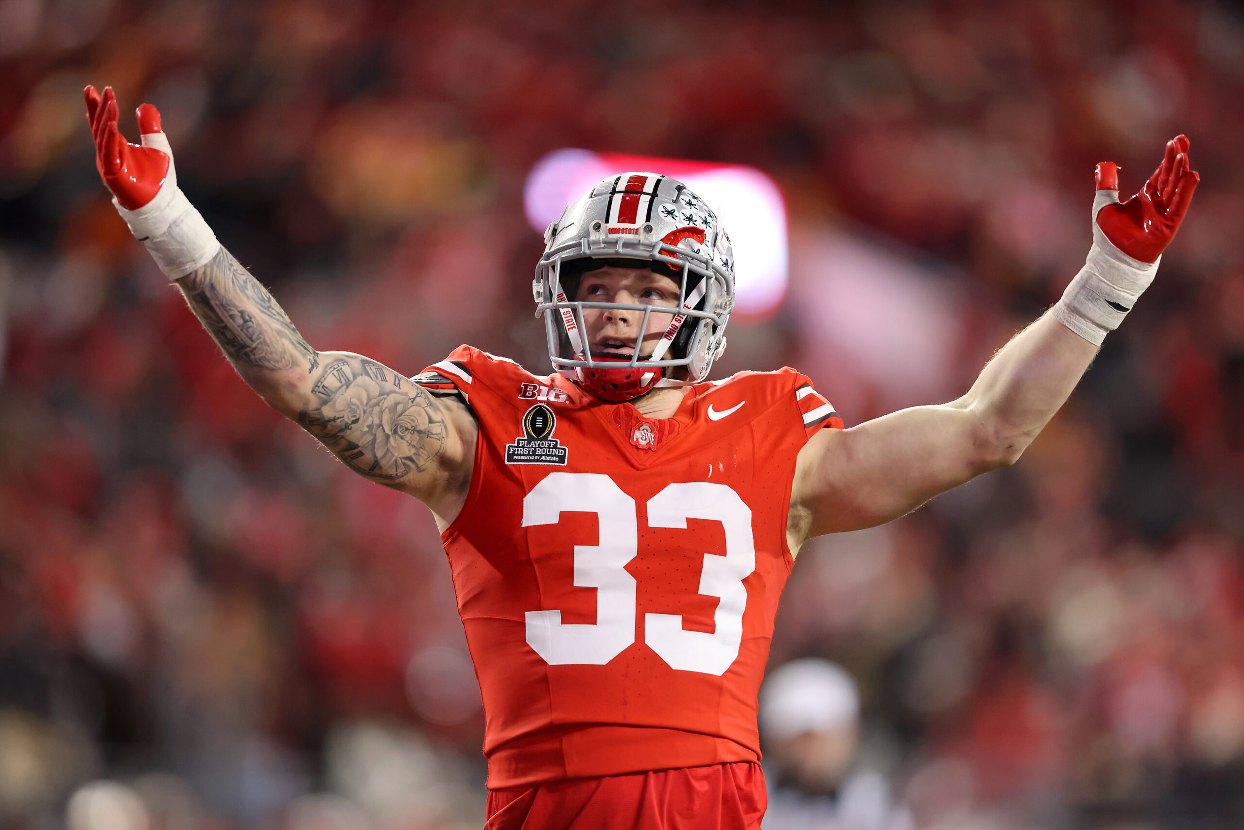Dec 21, 2024; Columbus, Ohio, USA; Ohio State Buckeyes defensive end Jack Sawyer (33) gets the crowd going during the second quarter against the Tennessee Volunteers at Ohio Stadium.