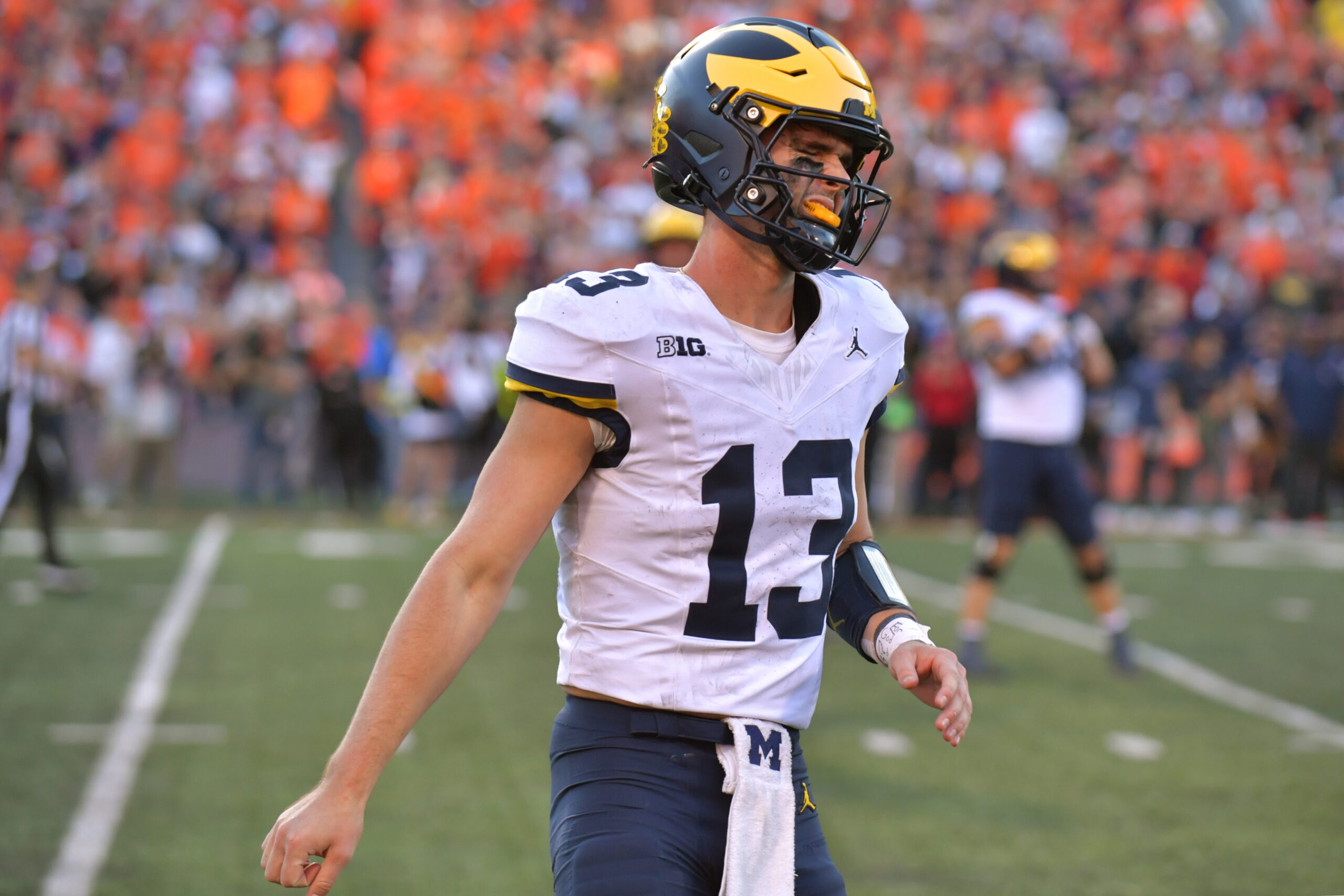 Oct 19, 2024; Champaign, Illinois, USA; Michigan Wolverines quarterback Jack Tuttle (13) reacts after turning over possession of the ball against the Illinois Fighting Illini during the second half at Memorial Stadium.
