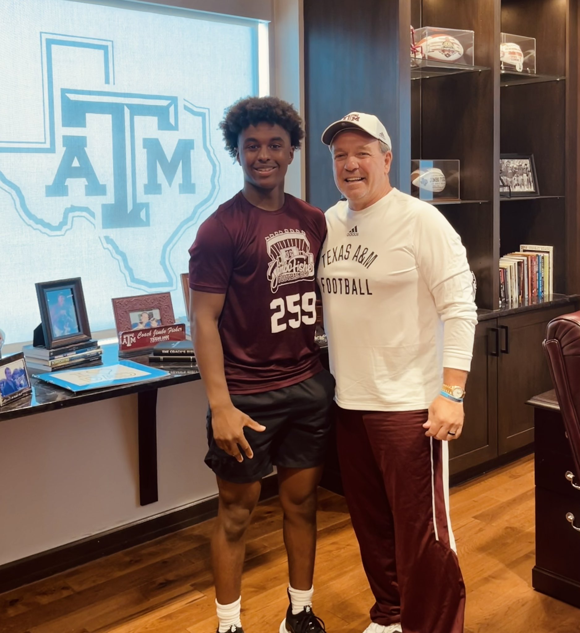 Mike Farrell Sports 2025 2-Star QB Jackson Hamilton from Manvel (TX) takes a picture with Jimbo Fisher during a 2023 Jimbo Fisher Football Camp