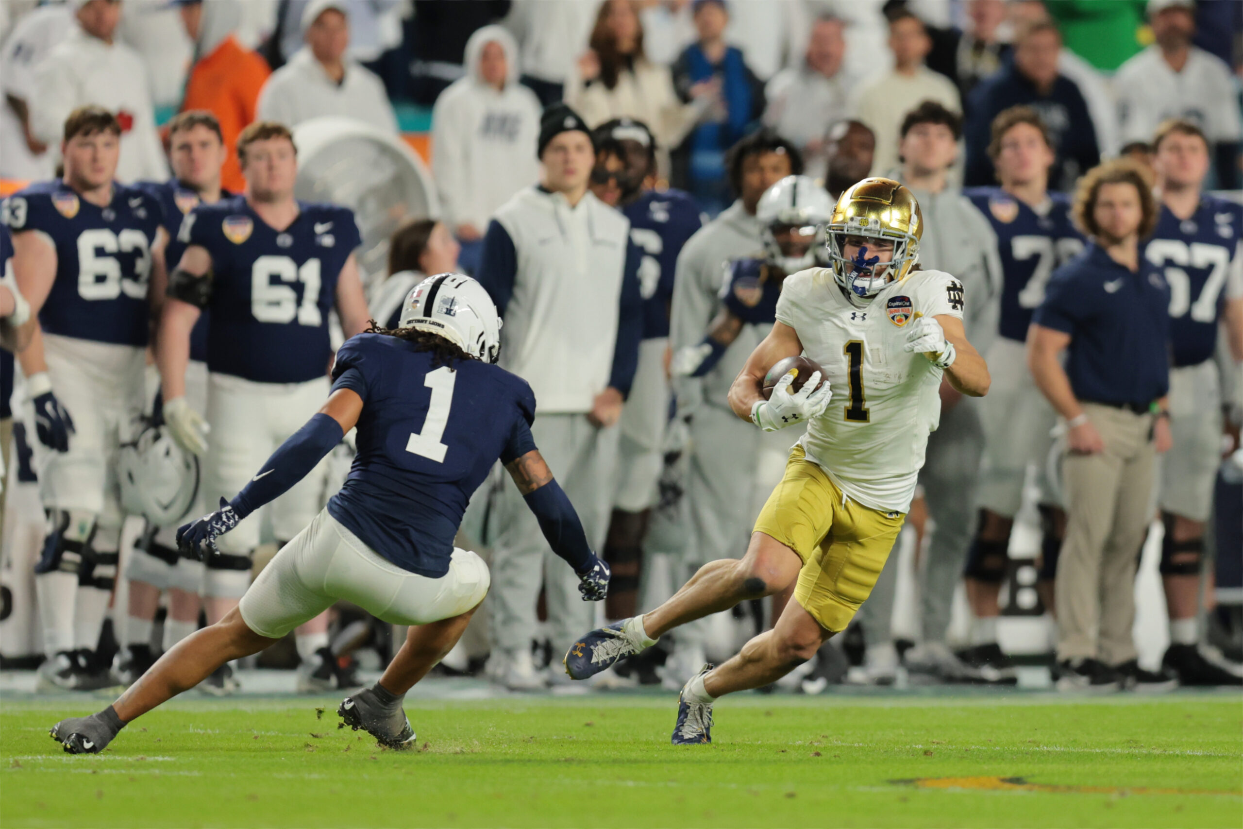 Jan 9, 2025; Miami, FL, USA; Notre Dame Fighting Irish wide receiver Jaden Greathouse (1) runs the ball in the second half against the Penn State Nittany Lions in the Orange Bowl at Hard Rock Stadium.