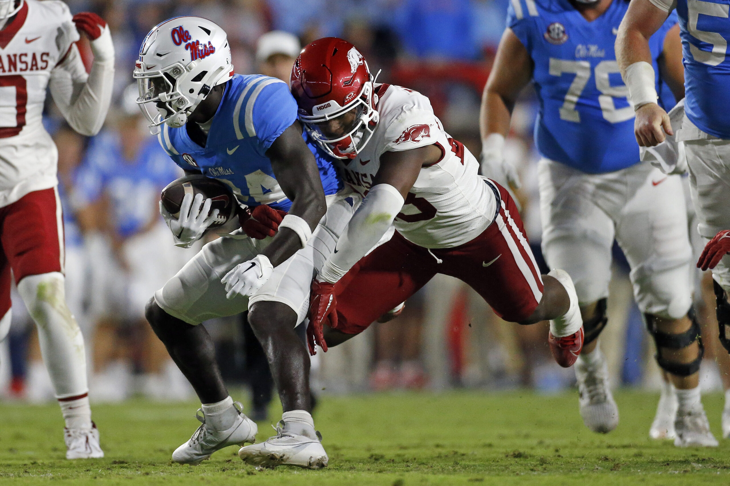 Oct 7, 2023; Oxford, Mississippi, USA; Mississippi Rebels running back Ulysses Bentley IV (24) runs the ball as Arkansas Razorbacks linebacker Jaheim Thomas (28) makes the tackle during the first half at Vaught-Hemingway Stadium.