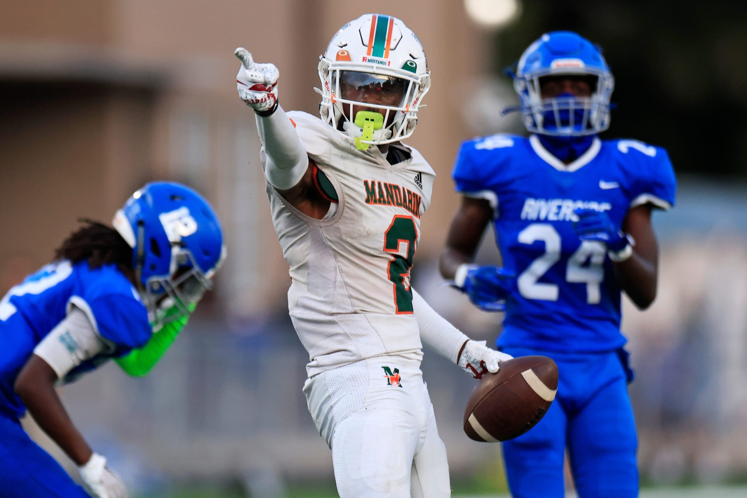 Mandarin's Jaime Ffrench Jr. (2) reacts to a first down pick up against Riverside's King Taylor (12) and Ronald 