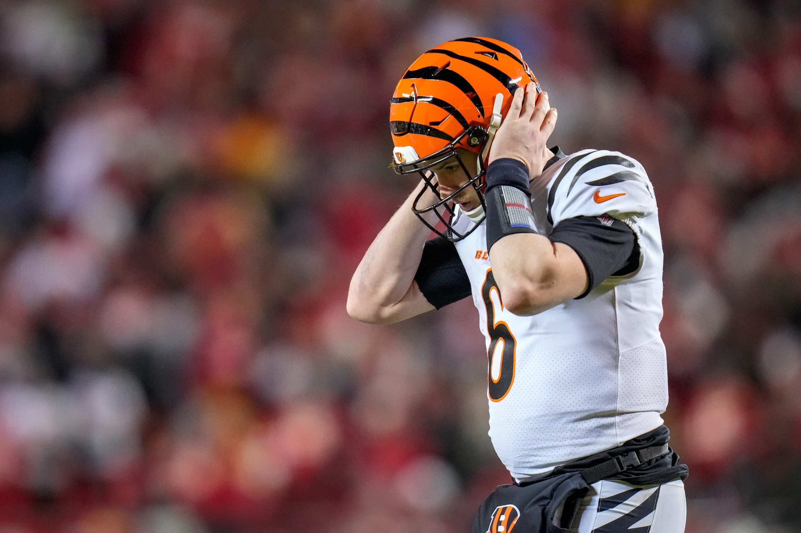 Cincinnati Bengals quarterback Jake Browning (6) takes a play over his headset in the fourth quarter of the NFL Week 17 game between the Kansas City Chiefs and the Cincinnati Bengals at Arrowhead Stadium in Kansas City, Mo., on Sunday, Dec. 31, 2023. The Chiefs won 25-17 to clinch the AFC West Championship.