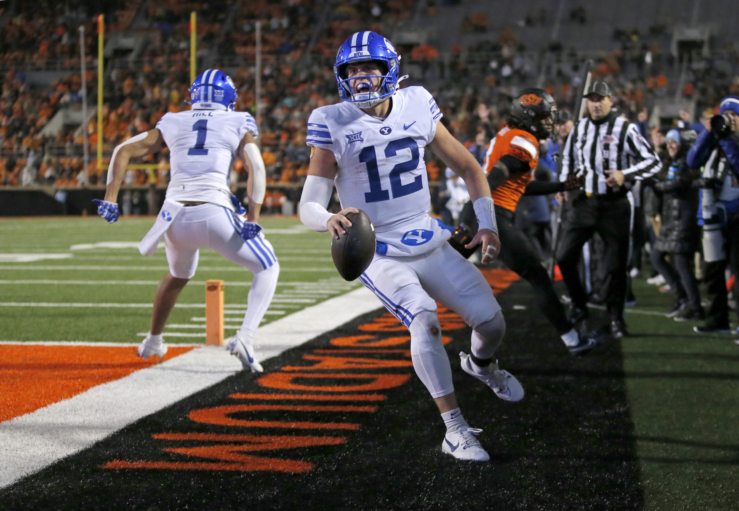 Nov 25, 2023; Stillwater, Oklahoma, USA; BYU's Jake Retzlaff (12) celebrates after scoring a touchdown in the first over time against the Oklahoma State University Cowboys at Boone Pickens Stadium.