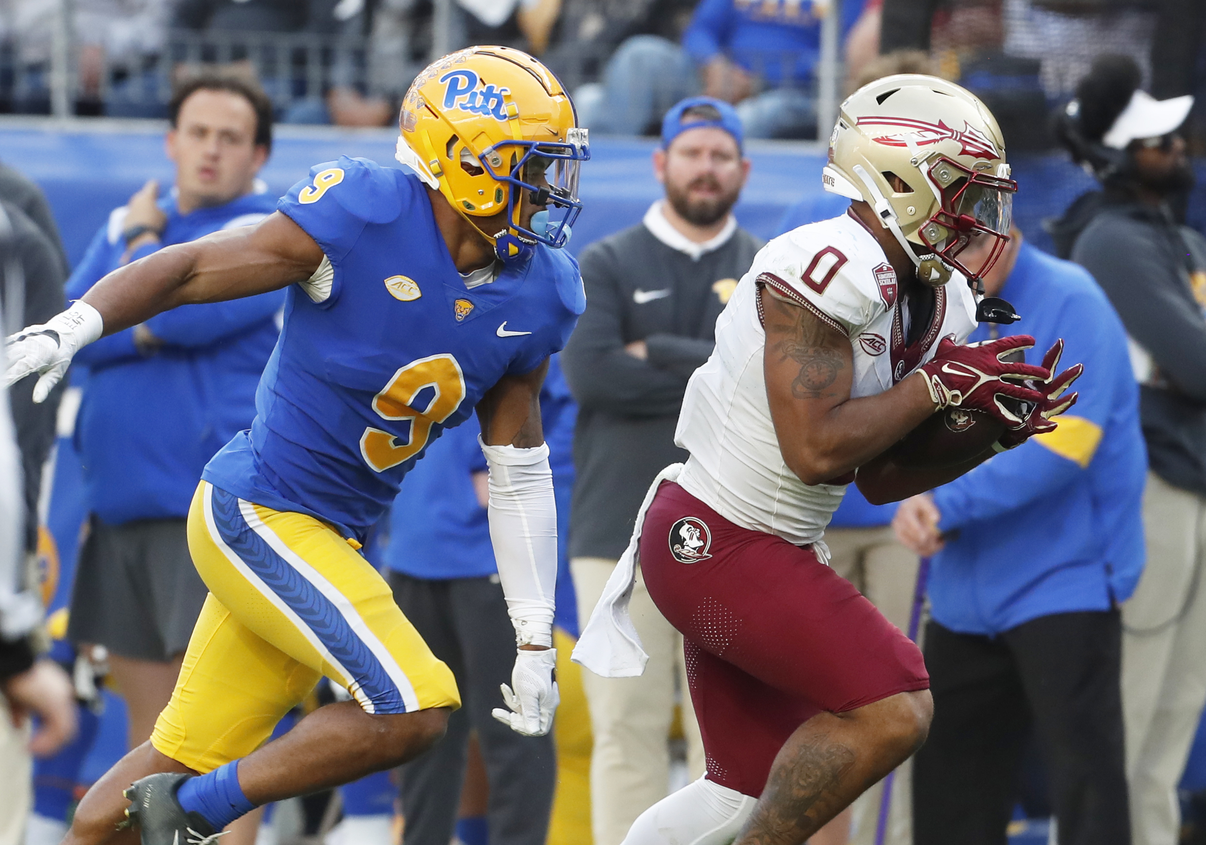 Nov 4, 2023; Pittsburgh, Pennsylvania, USA; Florida State Seminoles wide receiver Ja'Khi Douglas (0) catches a pass behind Pittsburgh Panthers defensive back A.J. Woods (9) during the second quarter at Acrisure Stadium.