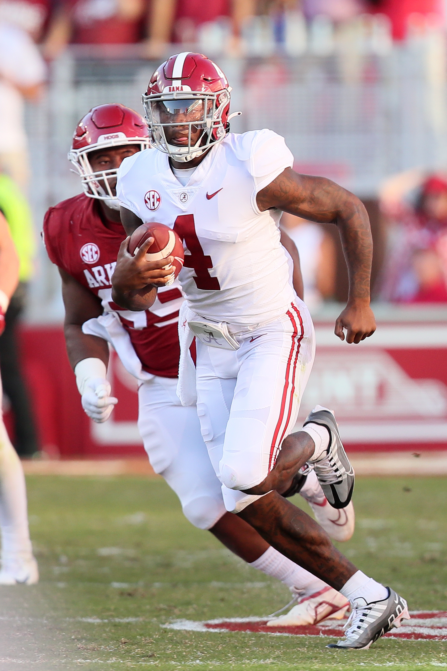 Oct 1, 2022; Fayetteville, Arkansas, USA; Alabama Crimson Tide quarterback Jalen Milroe (4) rushes in the fourth quarter against the Arkansas Razorbacks at Donald W. Reynolds Razorback Stadium. Alabama won 49-26.
