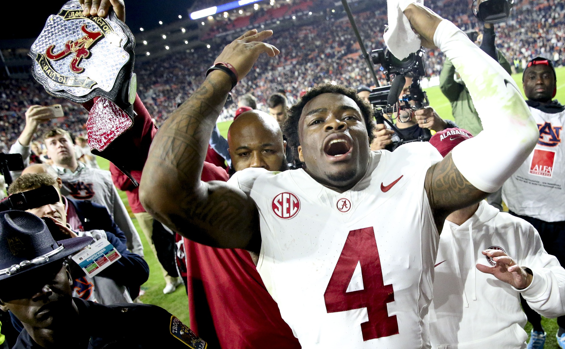 Nov 25, 2023; Auburn, Alabama, USA; Alabama Crimson Tide quarterback Jalen Milroe (4) celebrates after defeating the Auburn Tigers at Jordan-Hare Stadium. Alabama won 27-24.