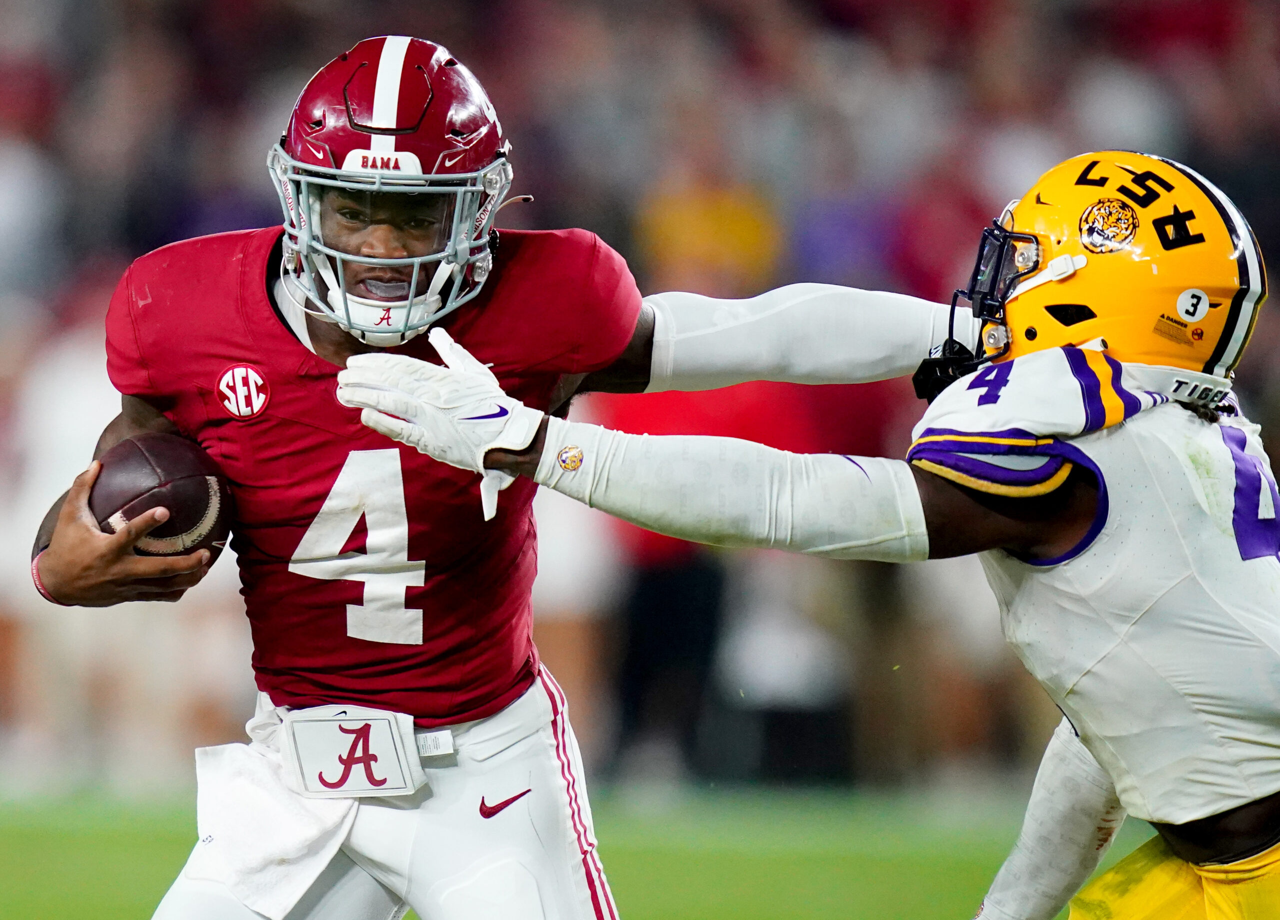 Nov 4, 2023; Tuscaloosa, Alabama, USA; Alabama Crimson Tide quarterback Jalen Milroe (4) scrambles up the field against LSU Tigers linebacker Harold Perkins Jr. (4) during the second half at Bryant-Denny Stadium. Alabama Crimson Tide defeated the LSU Tigers 42-28.