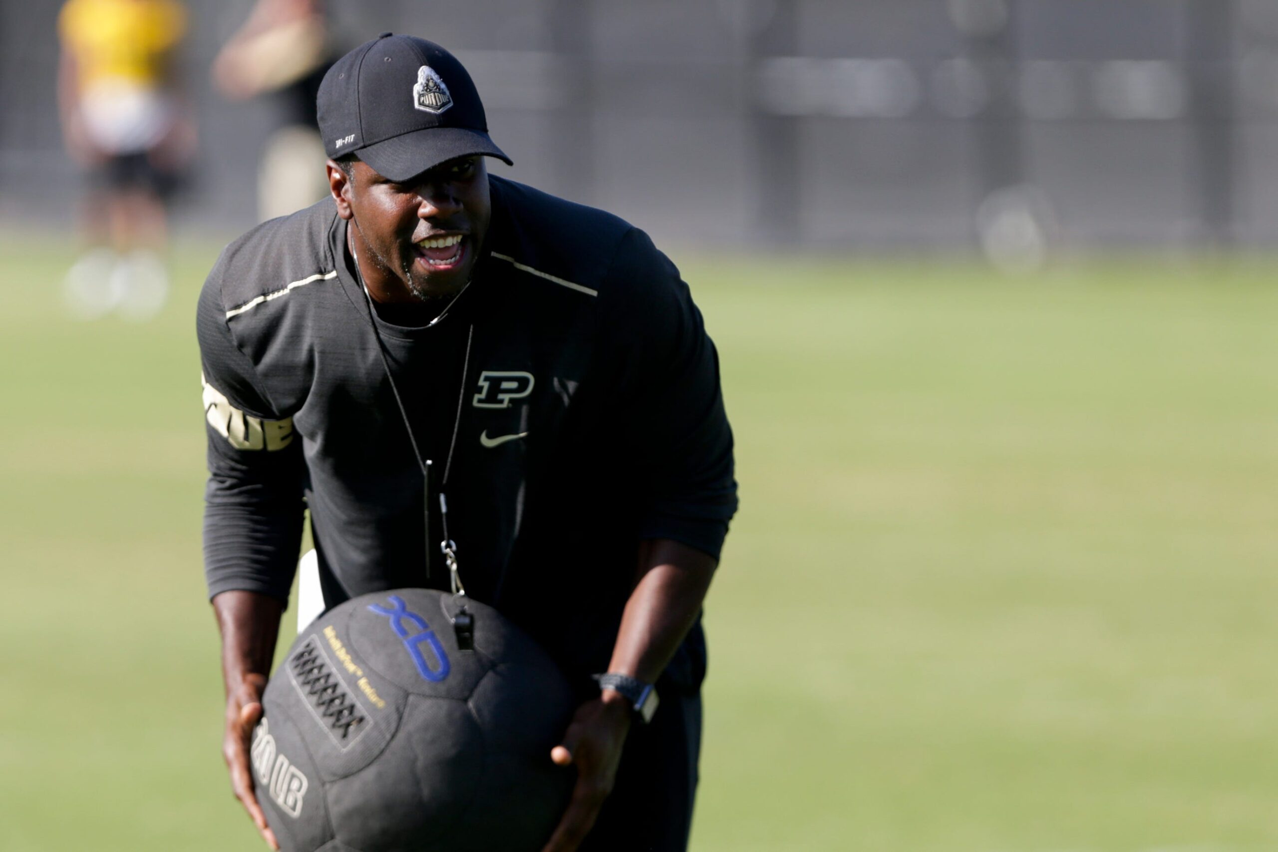 Purdue assistant coach JaMarcus Shephard holds a weighted ball during practice, Friday, Aug. 9, 2019 at Bimel Practice Complex in West Lafayette. Purdue Football Training Camp