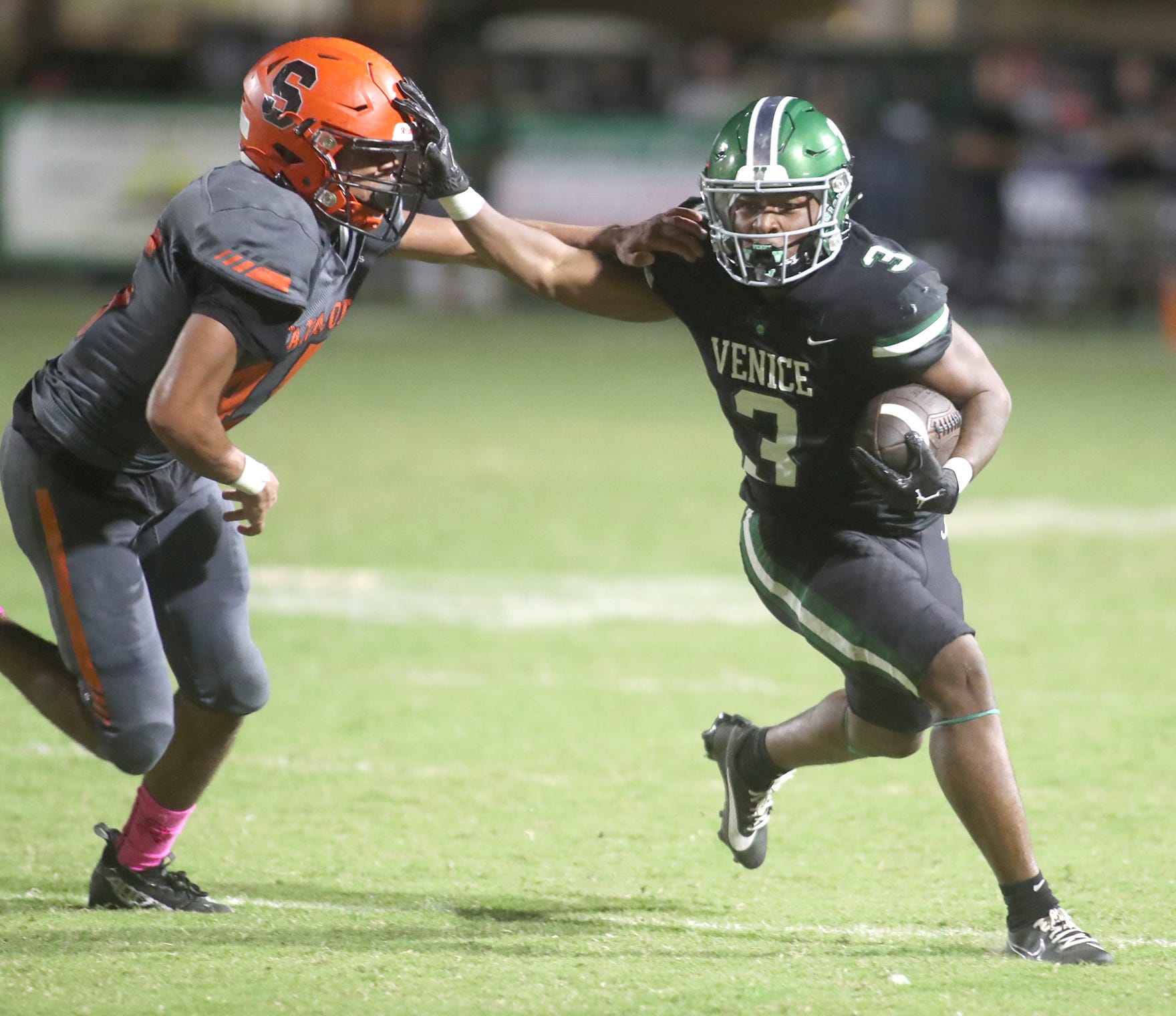 Venice runningback Jamarice Wilder (3) gets an edge on Sarasota Brian Klingel (45) during their matchup at Venice High School. Venice defeated Sarasota 44-14.
