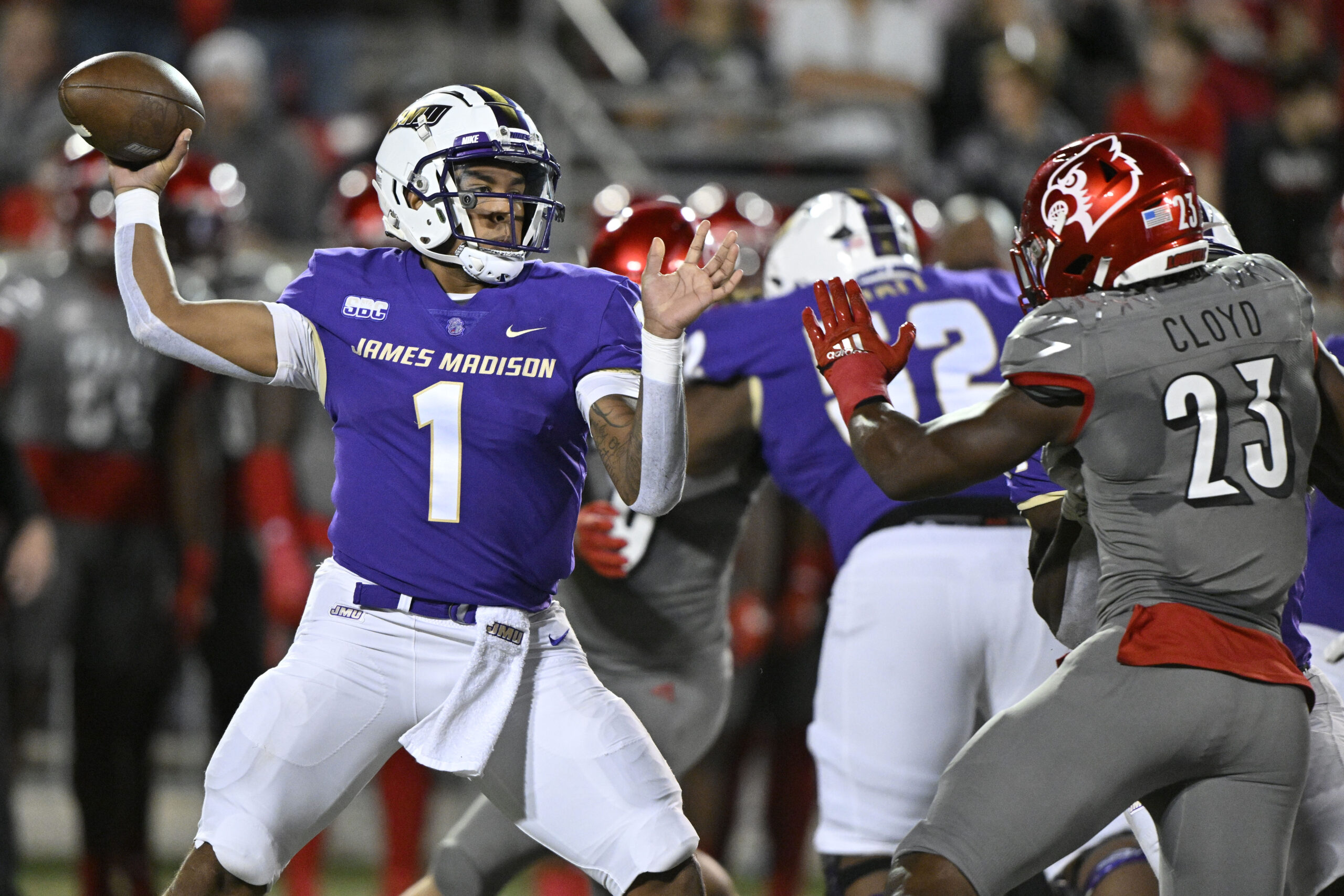 Nov 5, 2022; Louisville, Kentucky, USA; James Madison Dukes quarterback Todd Centeio (1) throws a pass against Louisville Cardinals linebacker K.J. Cloyd (23) during the first half at Cardinal Stadium.