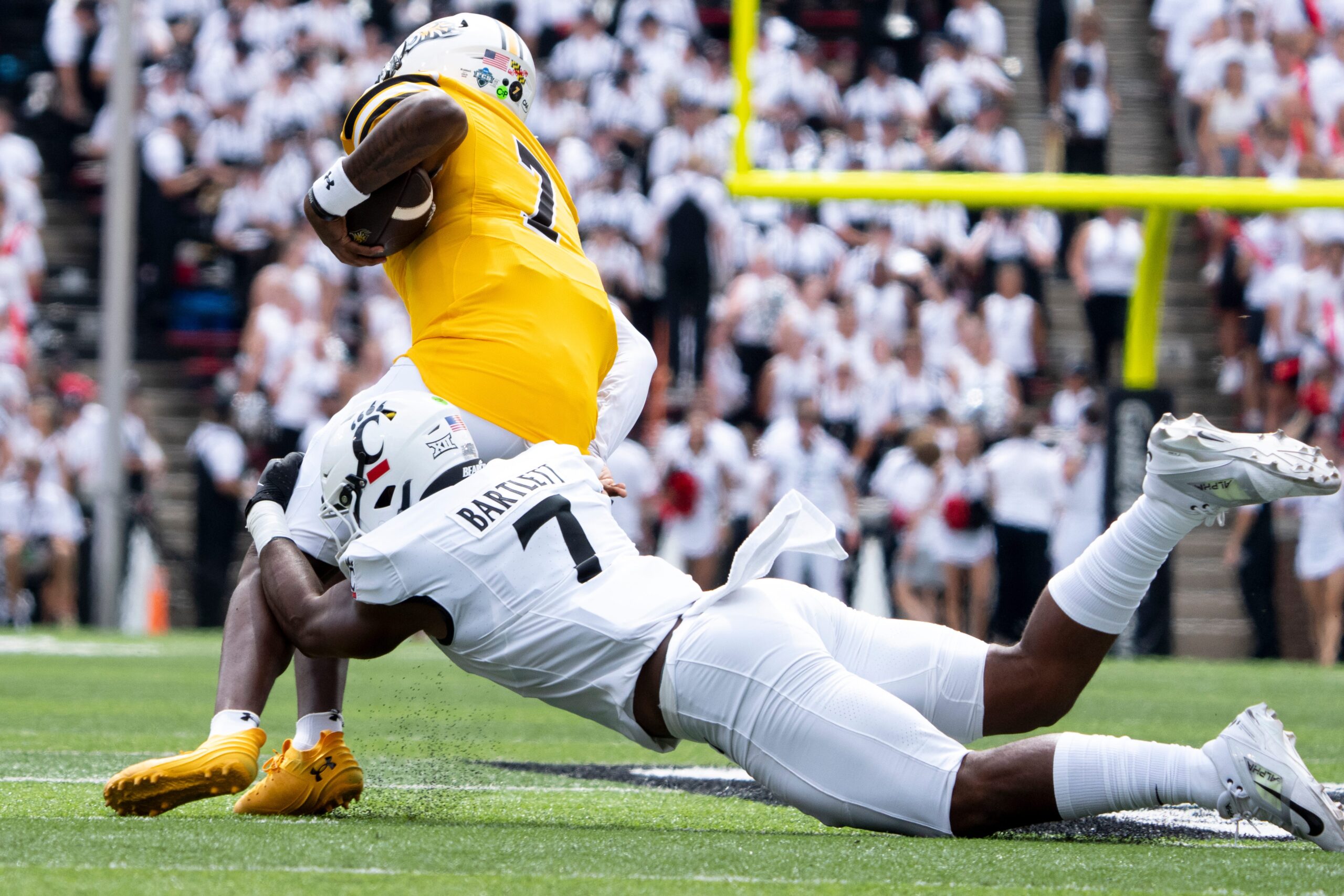 Cincinnati Bearcats linebacker Jared Bartlett (7) tackles Towson Tigers defensive back Kam Snell (7) in the first quarter of the College Football game at Nippert Stadium in Cincinnati on Saturday, Aug. 31, 2024.