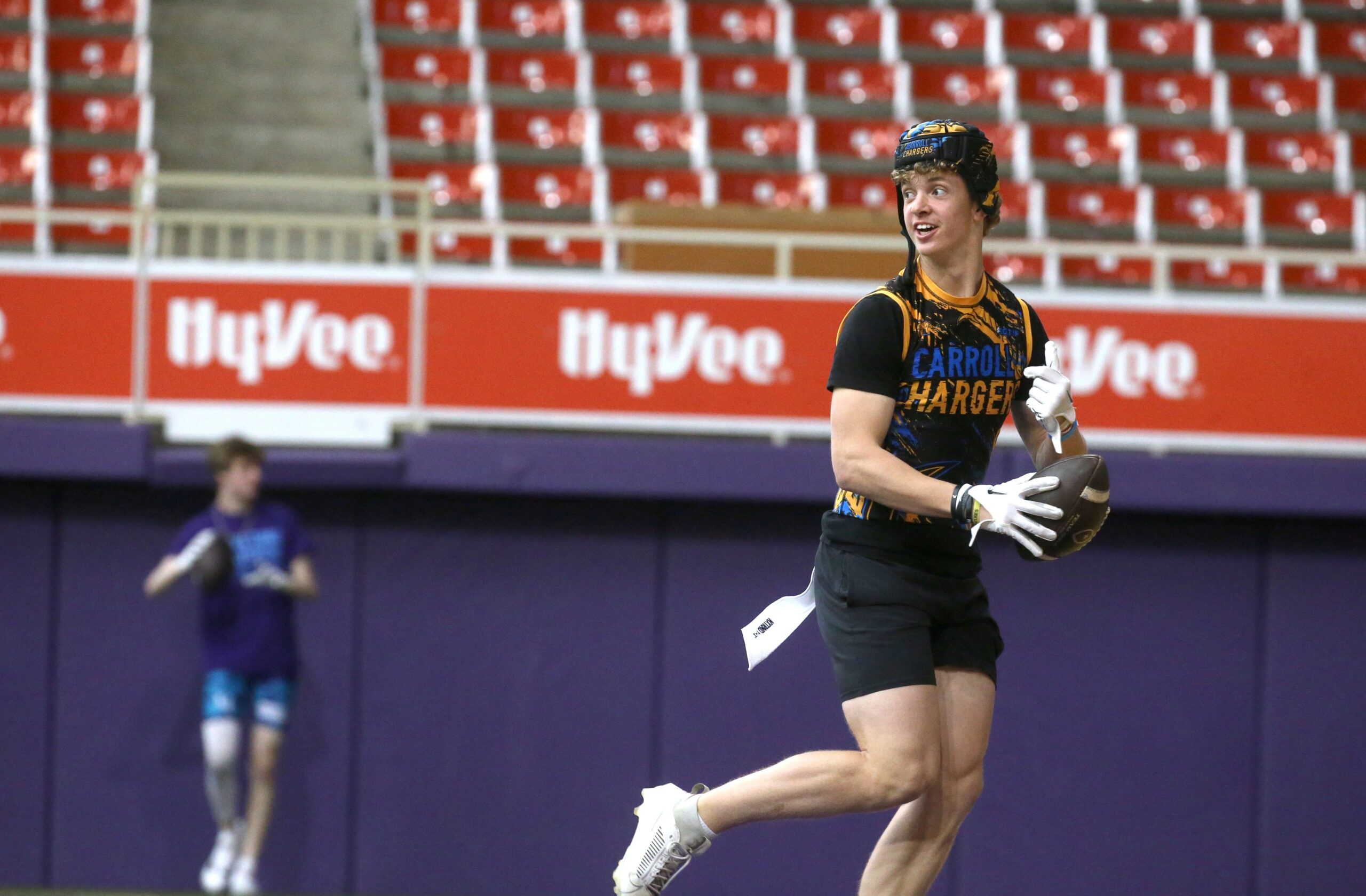 The Carroll Chargers’ Jaxx DeJean warms up before a 7-on-7 football tournament game Saturday, April 13, 2024 at the UNI Dome in Cedar Falls, Iowa.