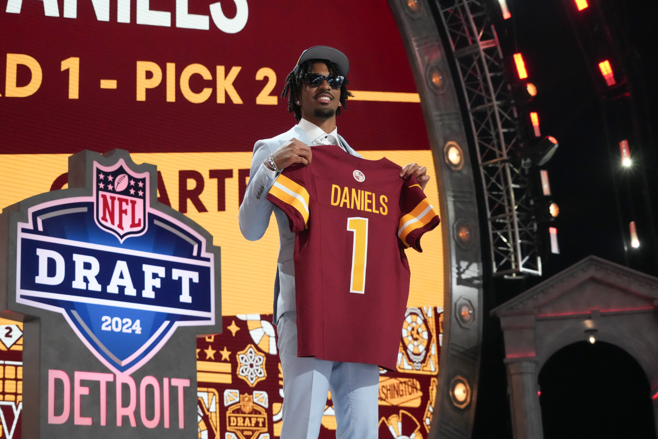 Apr 25, 2024; Detroit, MI, USA; LSU Tigers quarterback Jayden Daniels poses after being selected by the Washington Commanders as the No. 2 pick in the first round of the 2024 NFL Draft at Campus Martius Park and Hart Plaza.