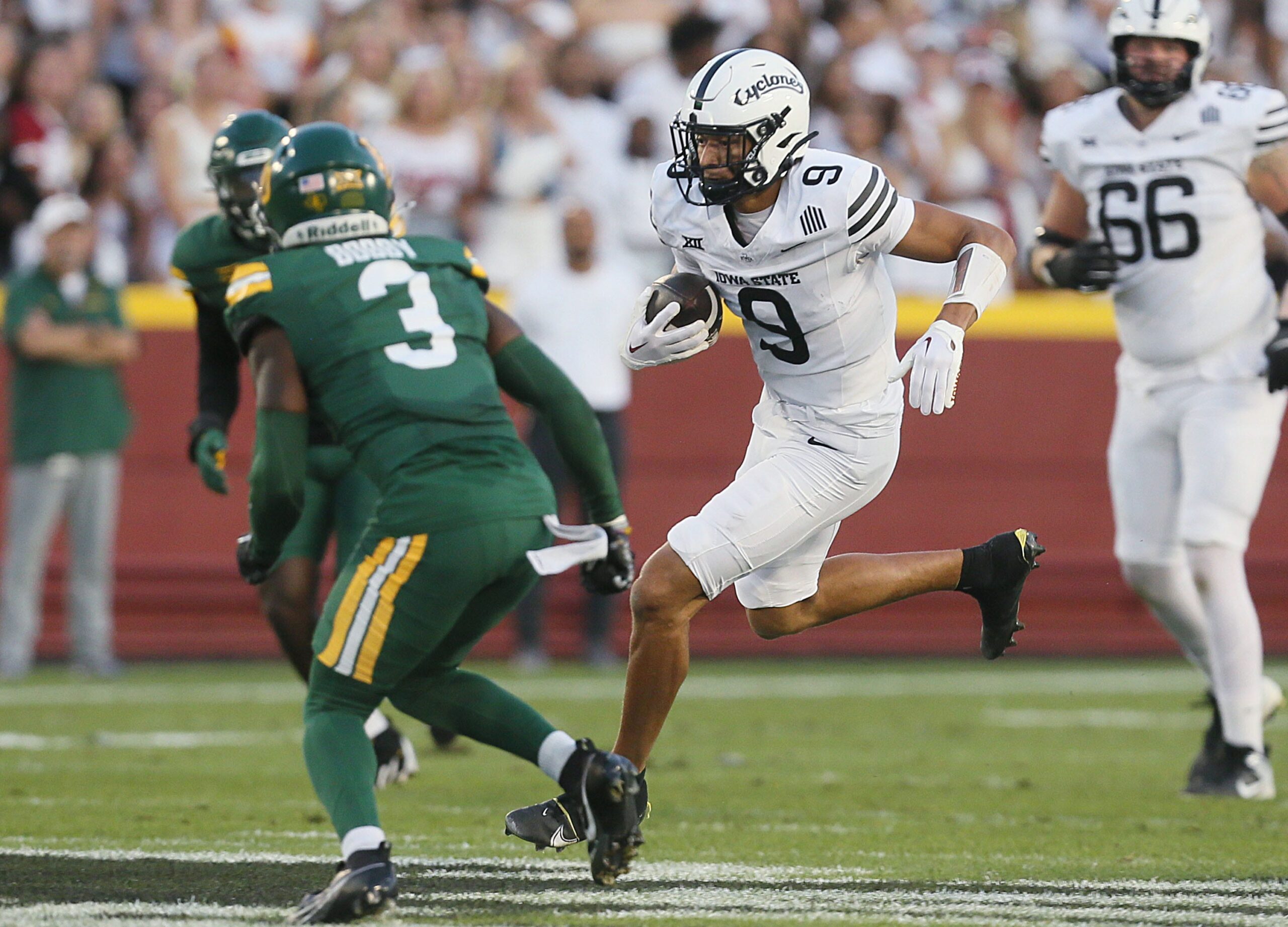 Iowa State Cyclones wide receiver Jayden Higgins (9) runs with the ball after making a catch around Baylor Bears safety Devyn Bobby (3) during the first quarter in the NCAA football at Jack Trice Stadium on Saturday, Oct. 5, 2024, in Ames, Iowa.