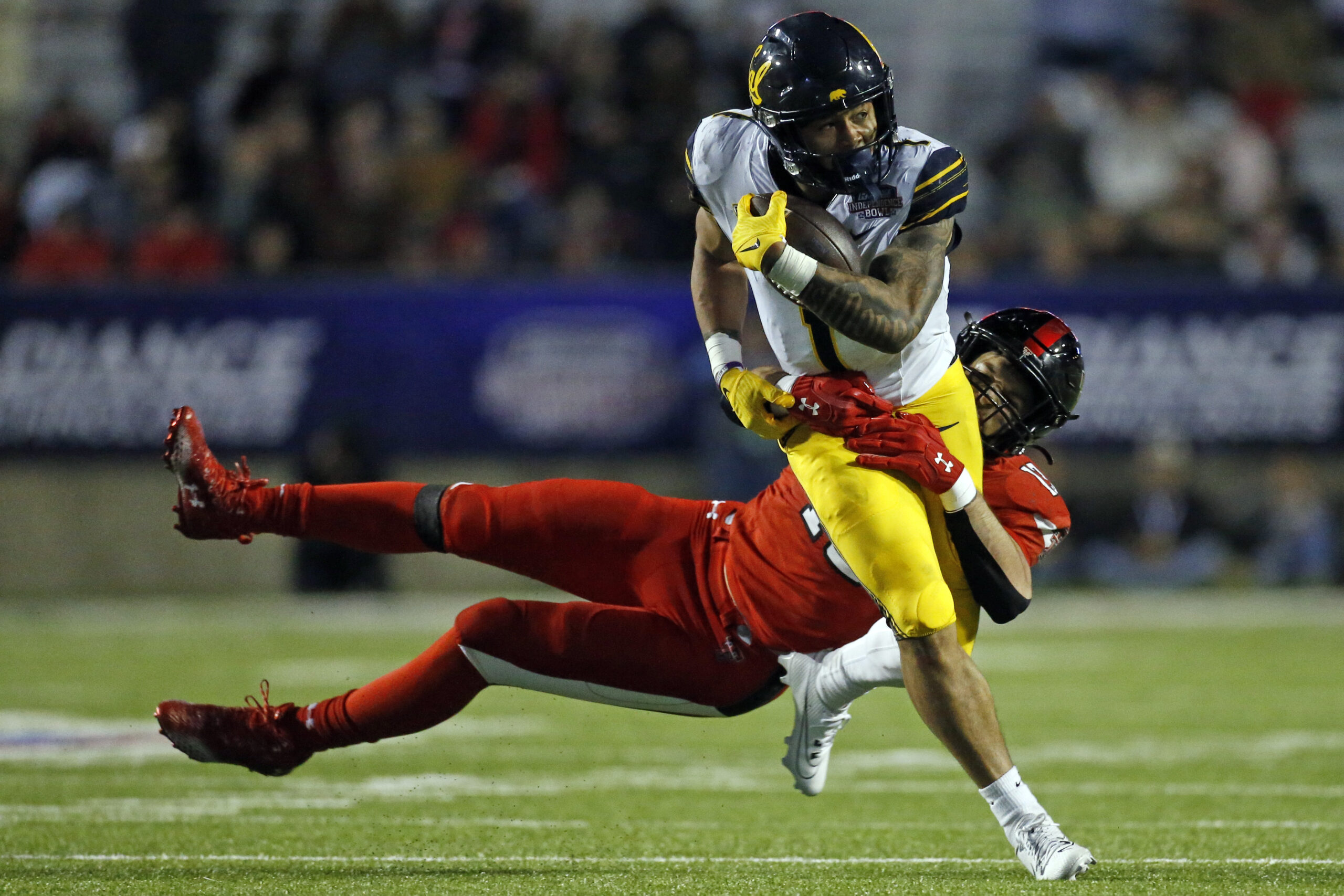Dec 16, 2023; Shreveport, LA, USA; California Golden Bears running back Jaydn Ott (1) runs the ball as Texas Tech Red Raiders linebacker Ben Roberts (13) makes the tackle during the second half at Independence Stadium.