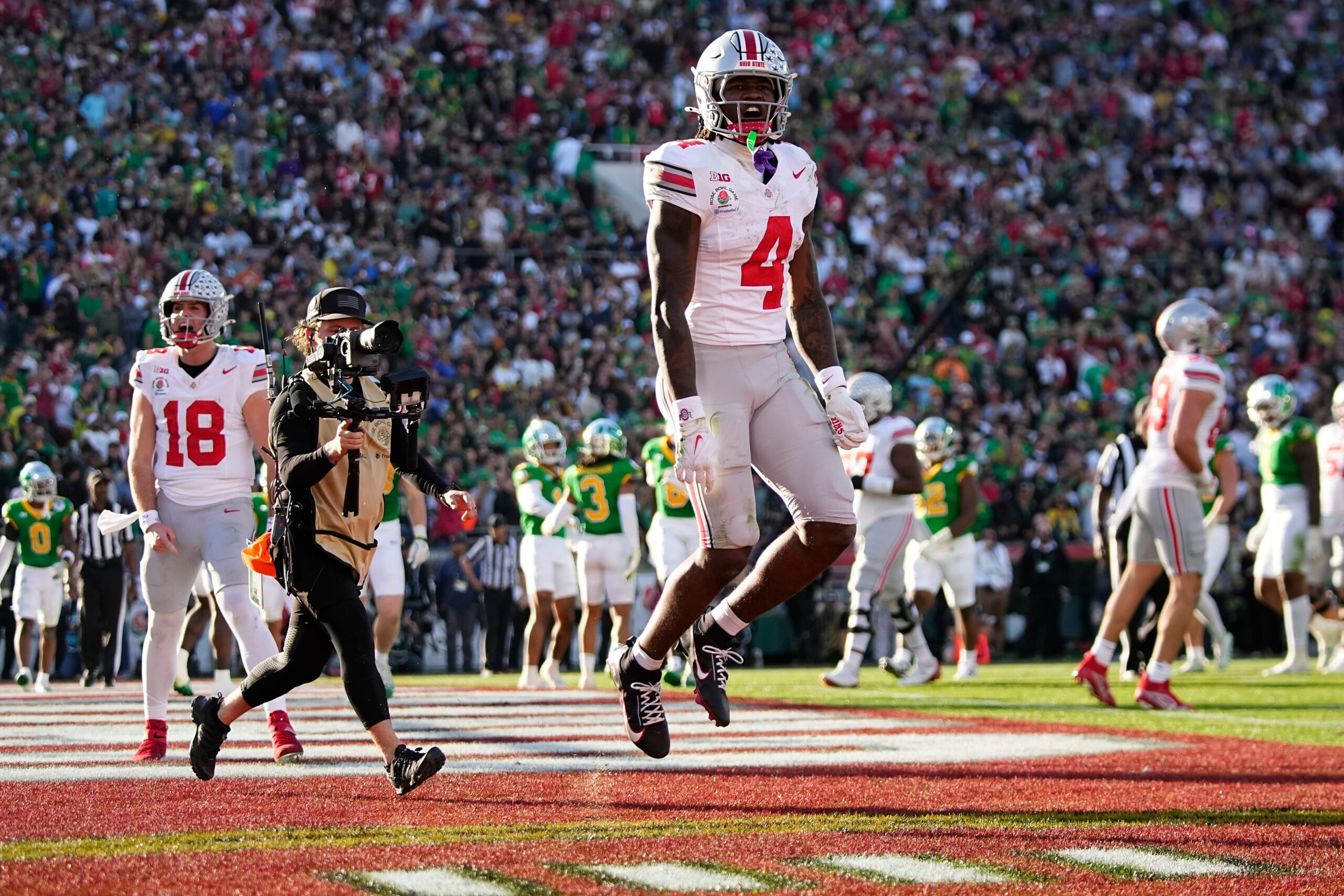 Ohio State Buckeyes wide receiver Jeremiah Smith (4) celebrates a touchdown during the first half of the College Football Playoff quarterfinal against the Oregon Ducks at the Rose Bowl in Pasadena