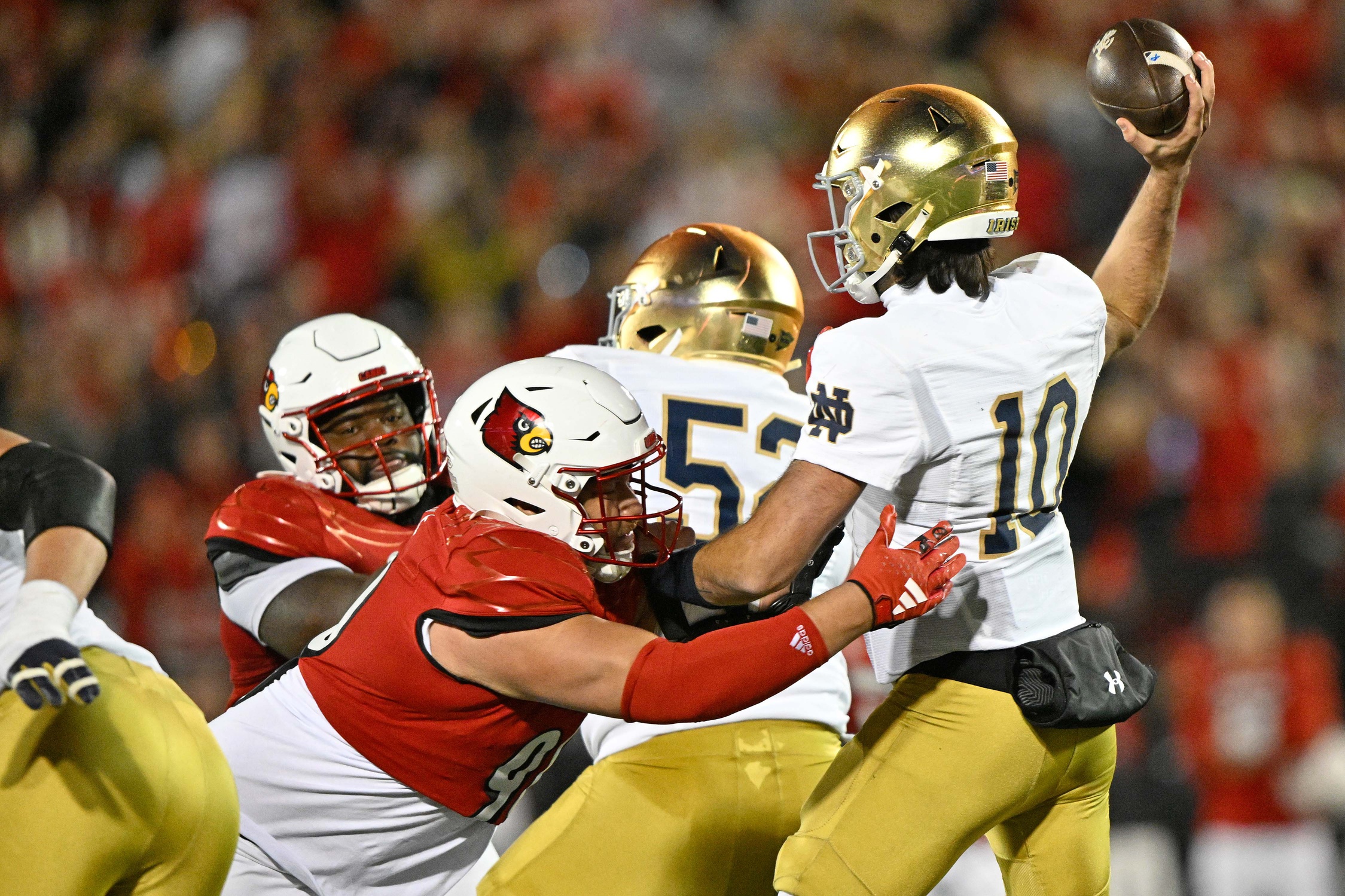Oct 7, 2023; Louisville, Kentucky, USA; Louisville Cardinals defensive lineman Jermayne Lole (90) pressures Notre Dame Fighting Irish quarterback Sam Hartman (10) during the second half at L&N Federal Credit Union Stadium. Louisville defeated Notre Dame 33-20.