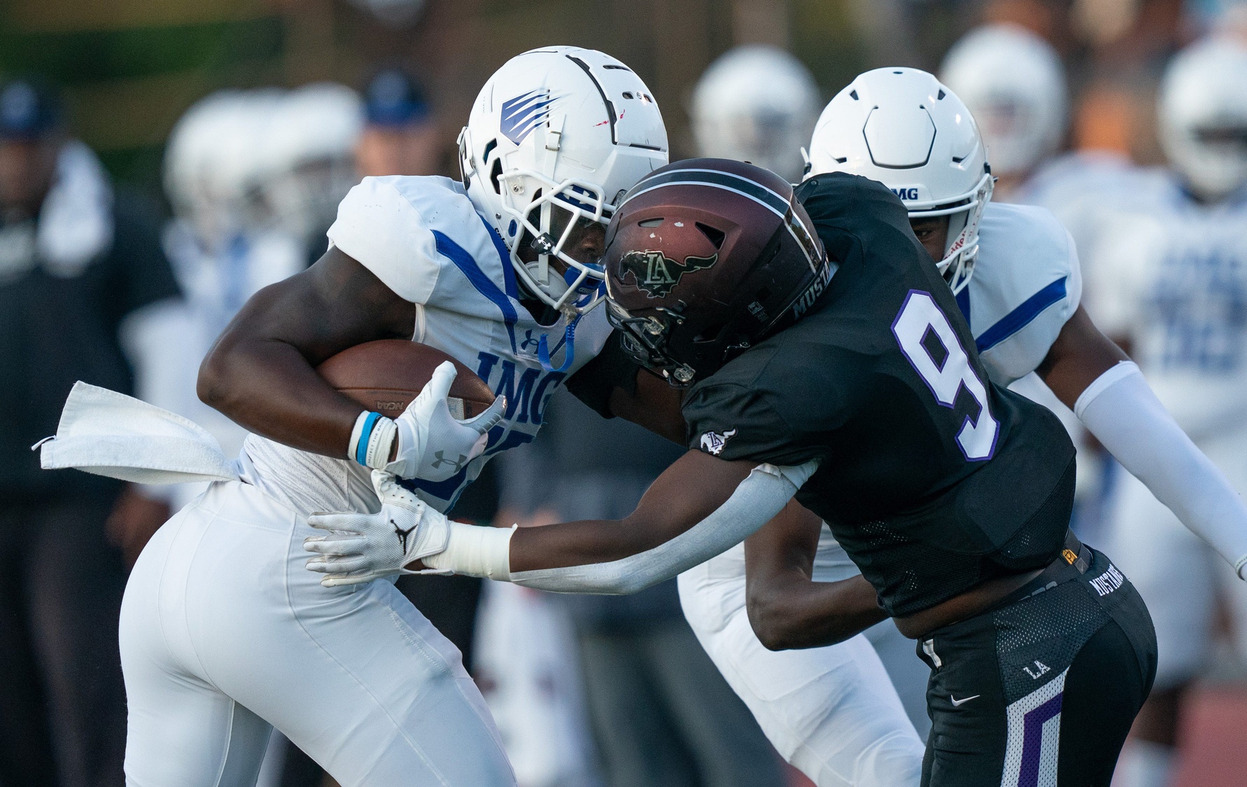 IMG's Jerrick Gibson (22) is met by Lipscomb's Kris Thompson (9) at Lipscomb's Reese Smith Football Field in Nashville, Tenn., Friday night, Aug. 18, 2023. IMG went on to win the game 35-10.