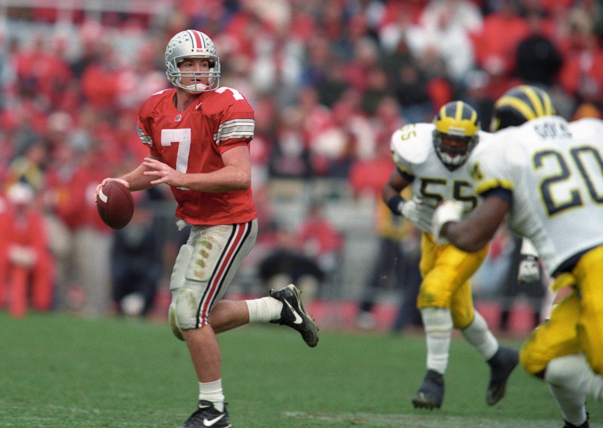 Nov 21, 1998; Columbus, OH, USA; Ohio State Buckeyes quarterback Joe Germaine (7) scrambles away from Michigan Wolverines defenders at Ohio Stadium.