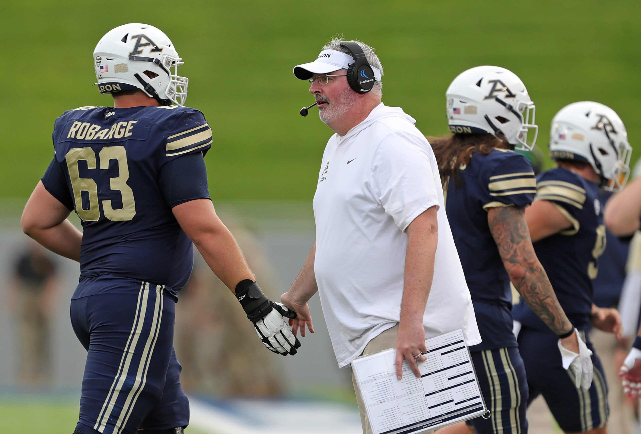 Akron Zips head coach Joe Moorhead celebrates with offensive lineman Alex Robarge during the first half, Saturday, Sept. 9, 2023.