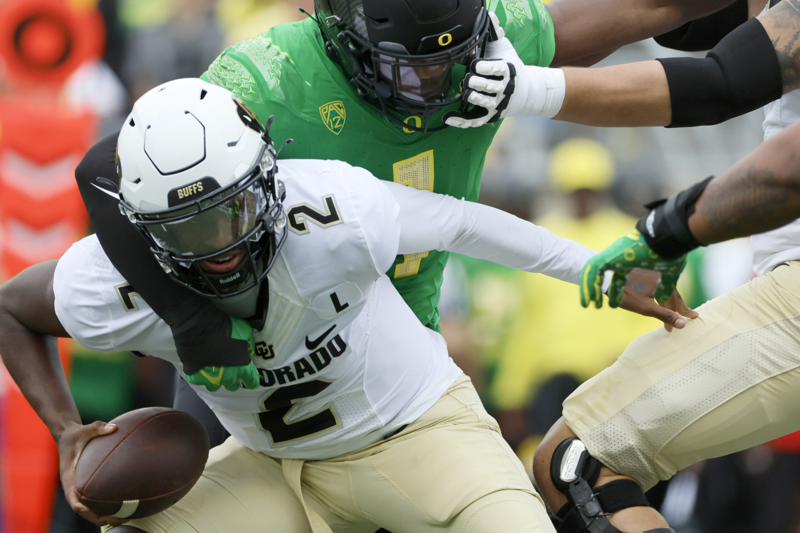 Sep 23, 2023; Eugene, Oregon, USA; Oregon Ducks defensive end Jordan Burch (1) sacks Colorado Buffaloes quarterback Shedeur Sanders (2) during the first half at Autzen Stadium.