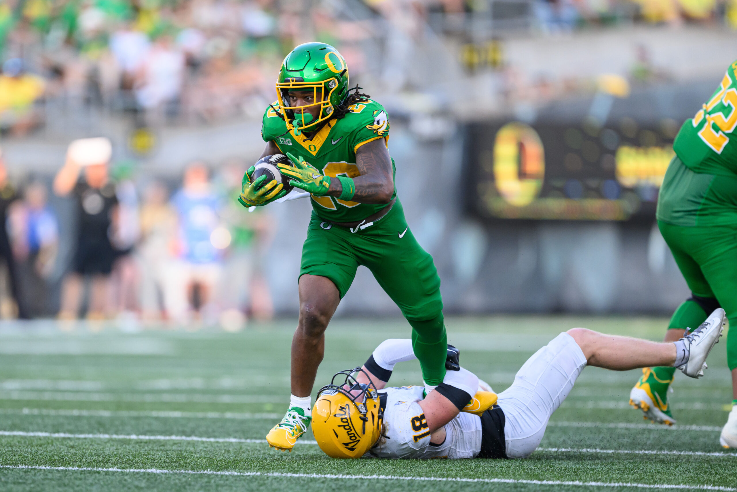 Aug 31, 2024; Eugene, Oregon, USA; Oregon Ducks running back Jordan James (20) drags tackler Idaho Vandals defensive back Tommy McCormick (18) during the second half at Autzen Stadium.