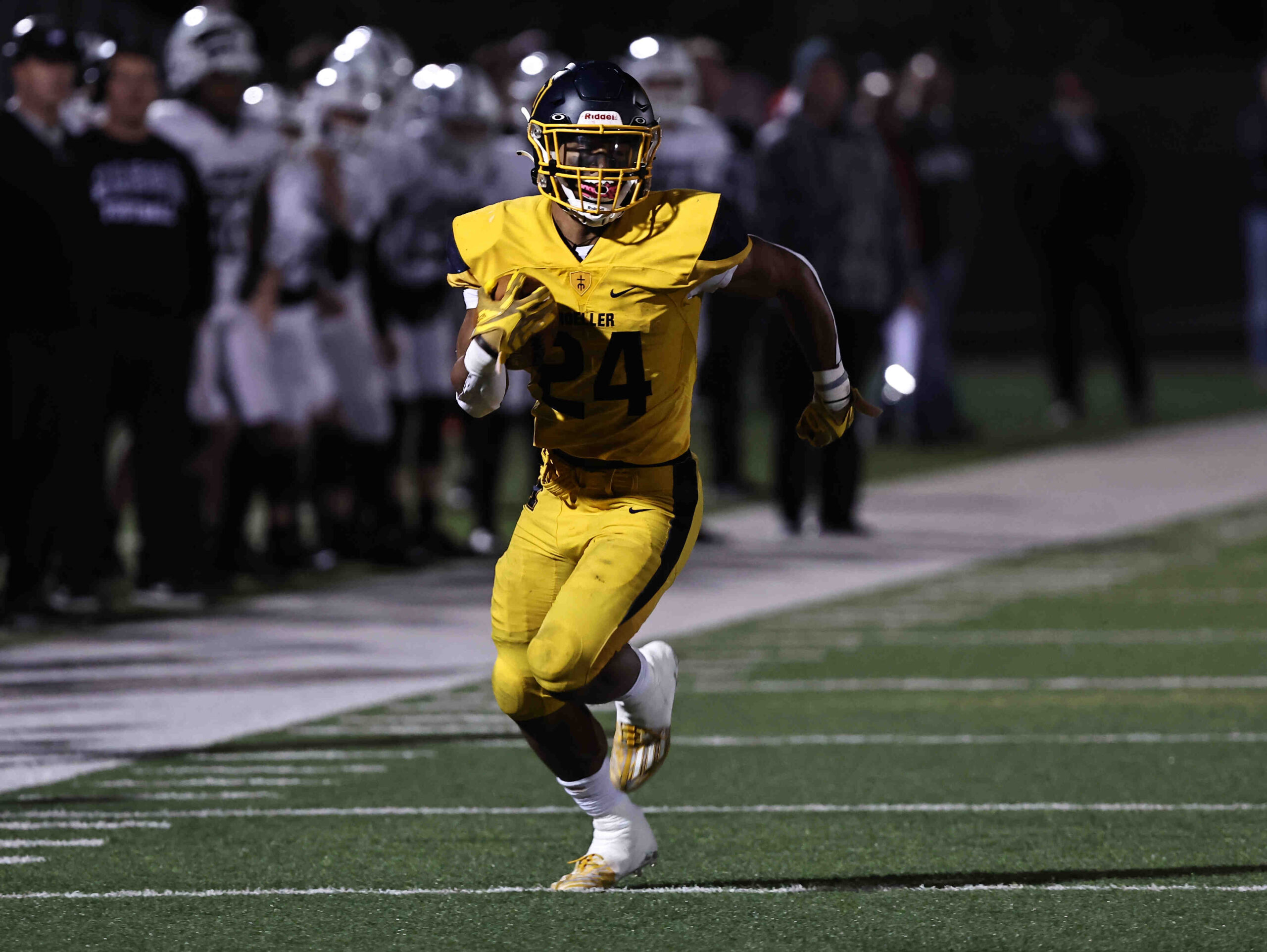 Moeller running back Jordan Marshall (24) carries the ball during a playoff game between Mason and Moeller high schools Friday, Nov. 11, 2022.