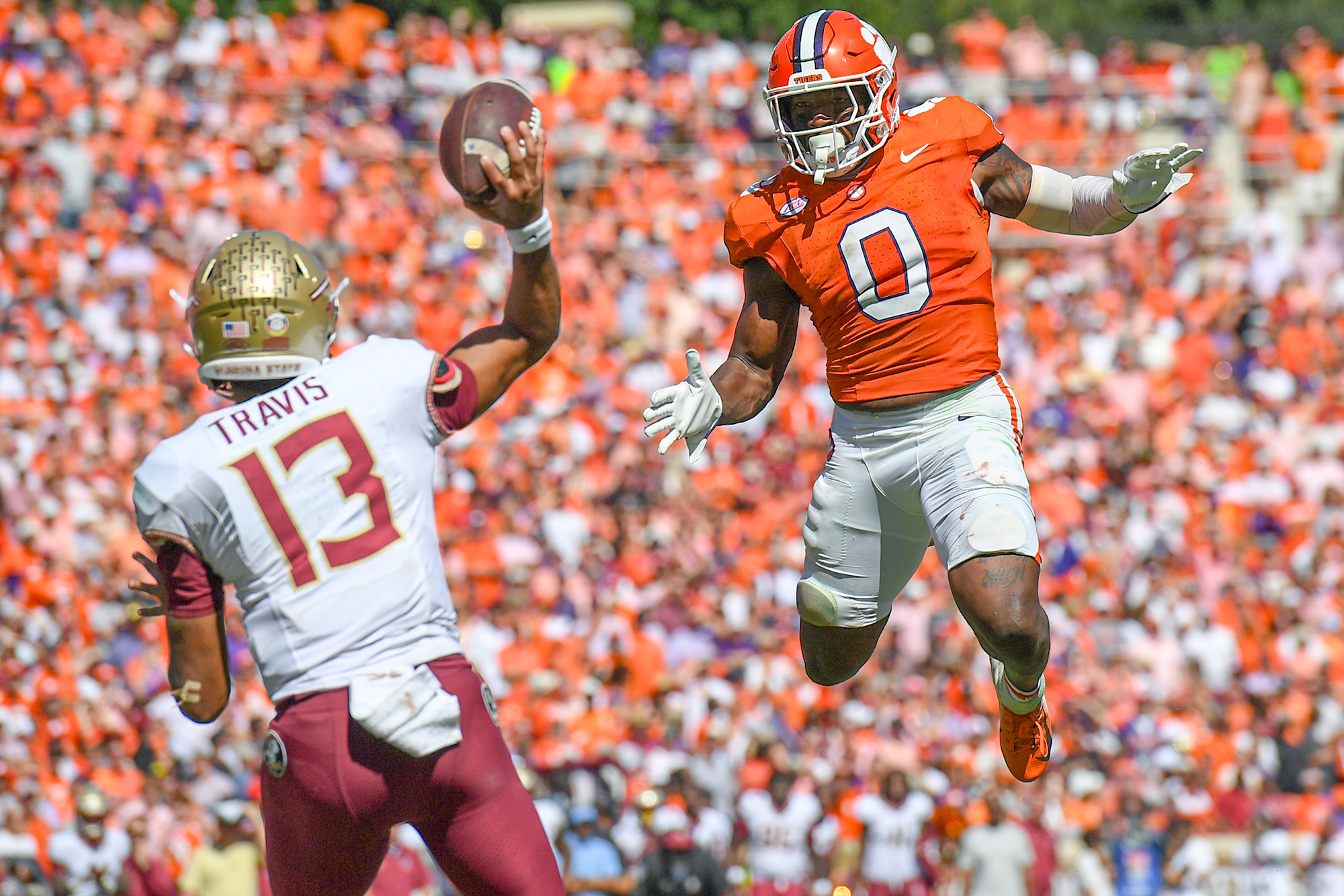 Sep 23, 2023; Clemson, South Carolina, USA; Clemson Tigers linebacker Barrett Carter (0) pressures Florida State Seminoles quarterback Jordan Travis (13) during the fourth quarter at Memorial Stadium.