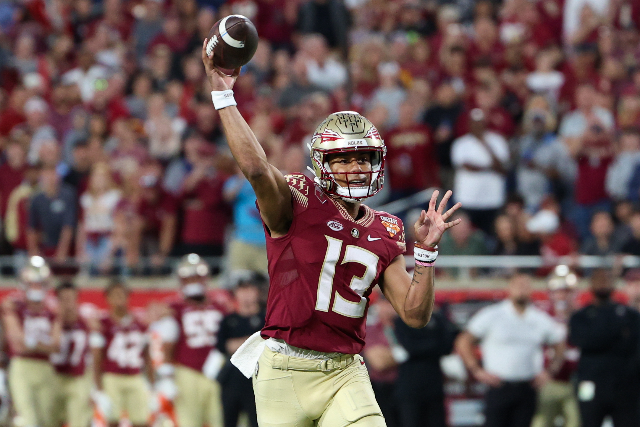 Dec 29, 2022; Orlando, Florida, USA; Florida State Seminoles quarterback Jordan Travis (13) drops back to pass against the Oklahoma Sooners in the first quarter during the 2022 Cheez-It Bowl at Camping World Stadium.