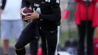 Lakota East Thunderhawks quarterback JT Kitna (4) rolls out of the pocket in the first half of a high school football game between the Lakota West Firebirds and the Lakota East Thunderhawks