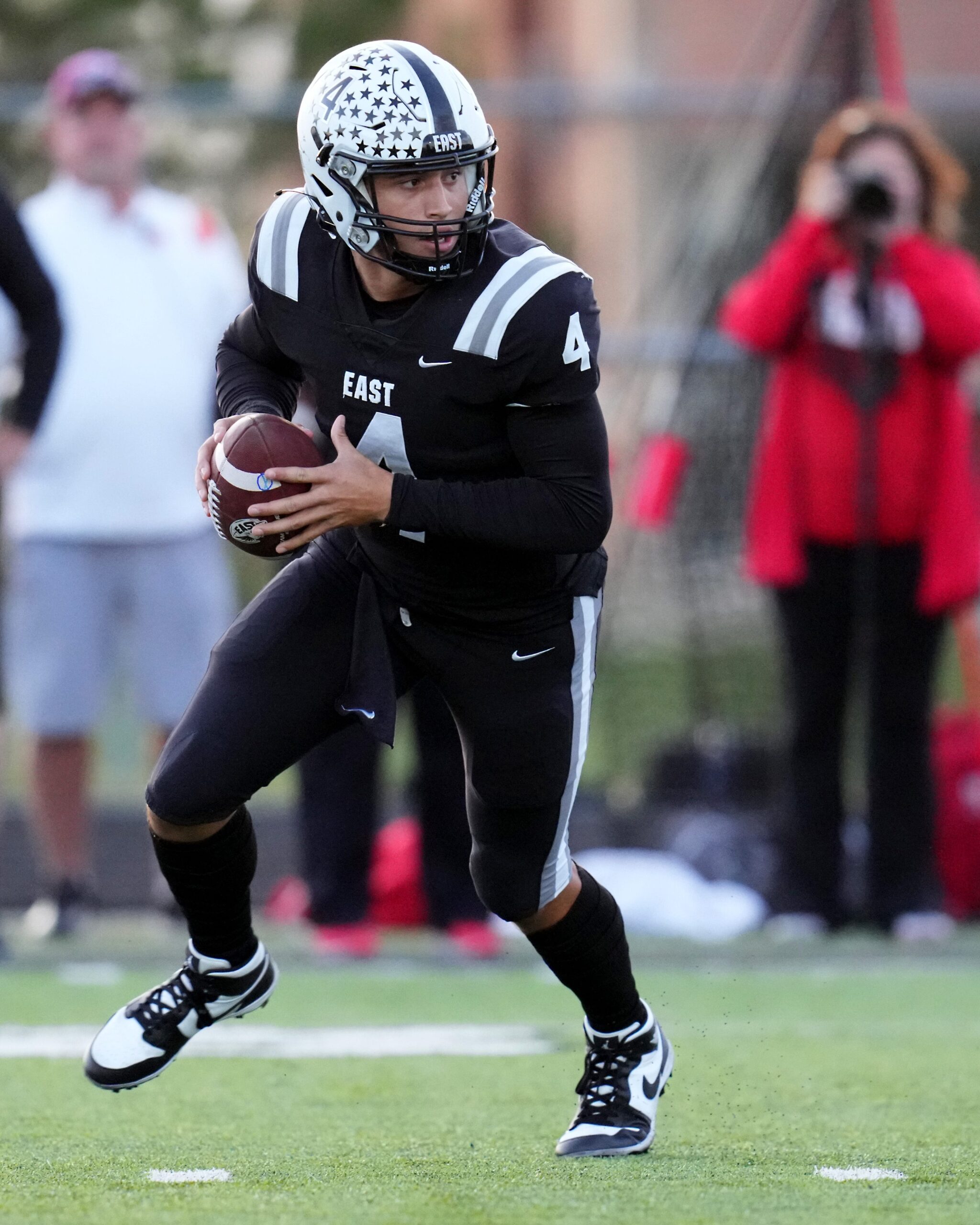 Lakota East Thunderhawks quarterback JT Kitna (4) rolls out of the pocket in the first half of a high school football game between the Lakota West Firebirds and the Lakota East Thunderhawks, Friday, Oct. 6, 2023, at Lakota East High School in Liberty Township, Ohio.