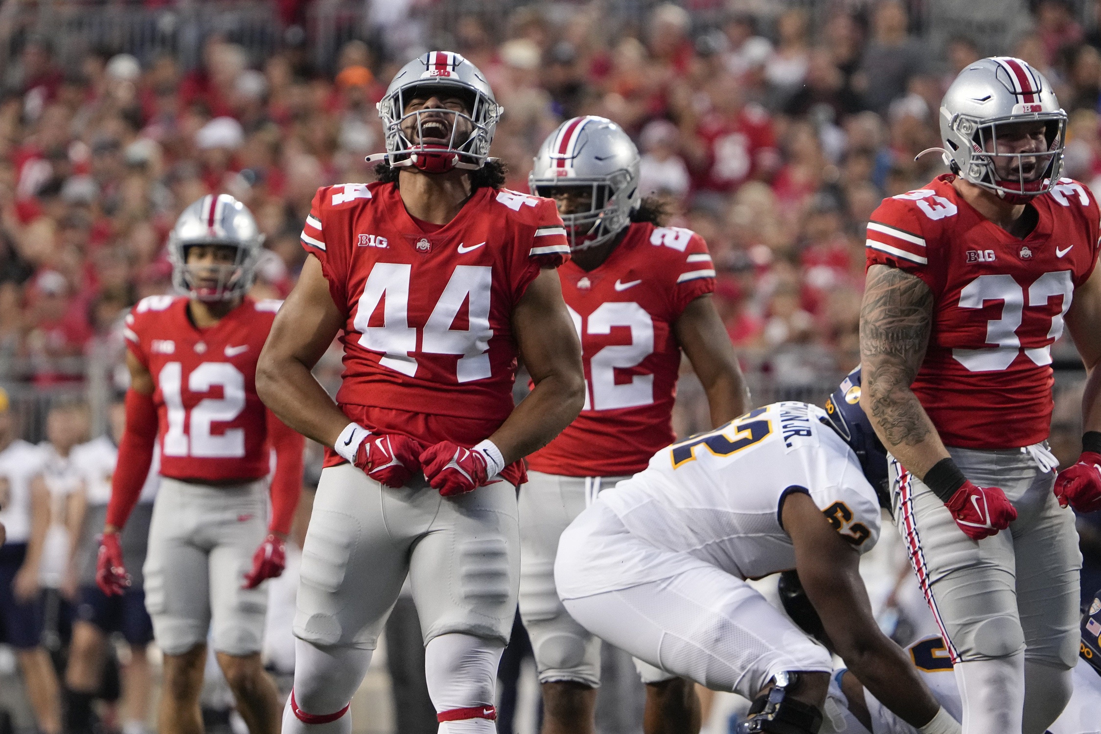 Sep 17, 2022; Columbus, Ohio, USA; Ohio State Buckeyes defensive end J.T. Tuimoloau (44) celebrates a tackle during the first half of the NCAA Division I football game against the Toledo Rockets at Ohio Stadium.