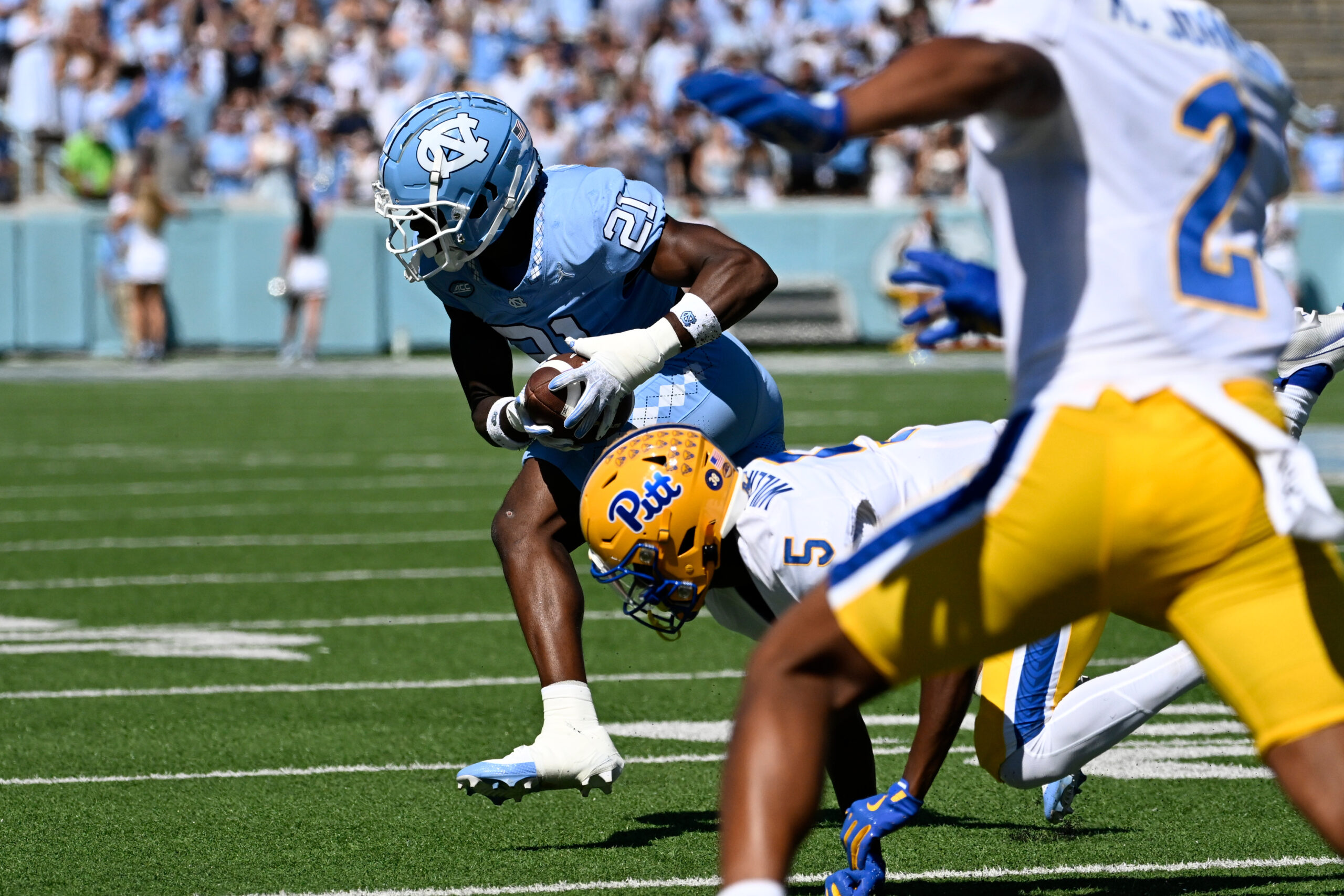 Oct 5, 2024; Chapel Hill, North Carolina, USA; North Carolina Tar Heels defensive back Kaleb Cost (21) intercepts a pass intended for Pittsburgh Panthers wide reciever Raphael Williams Jr. (5) in the first quarter at Kenan Memorial Stadium.